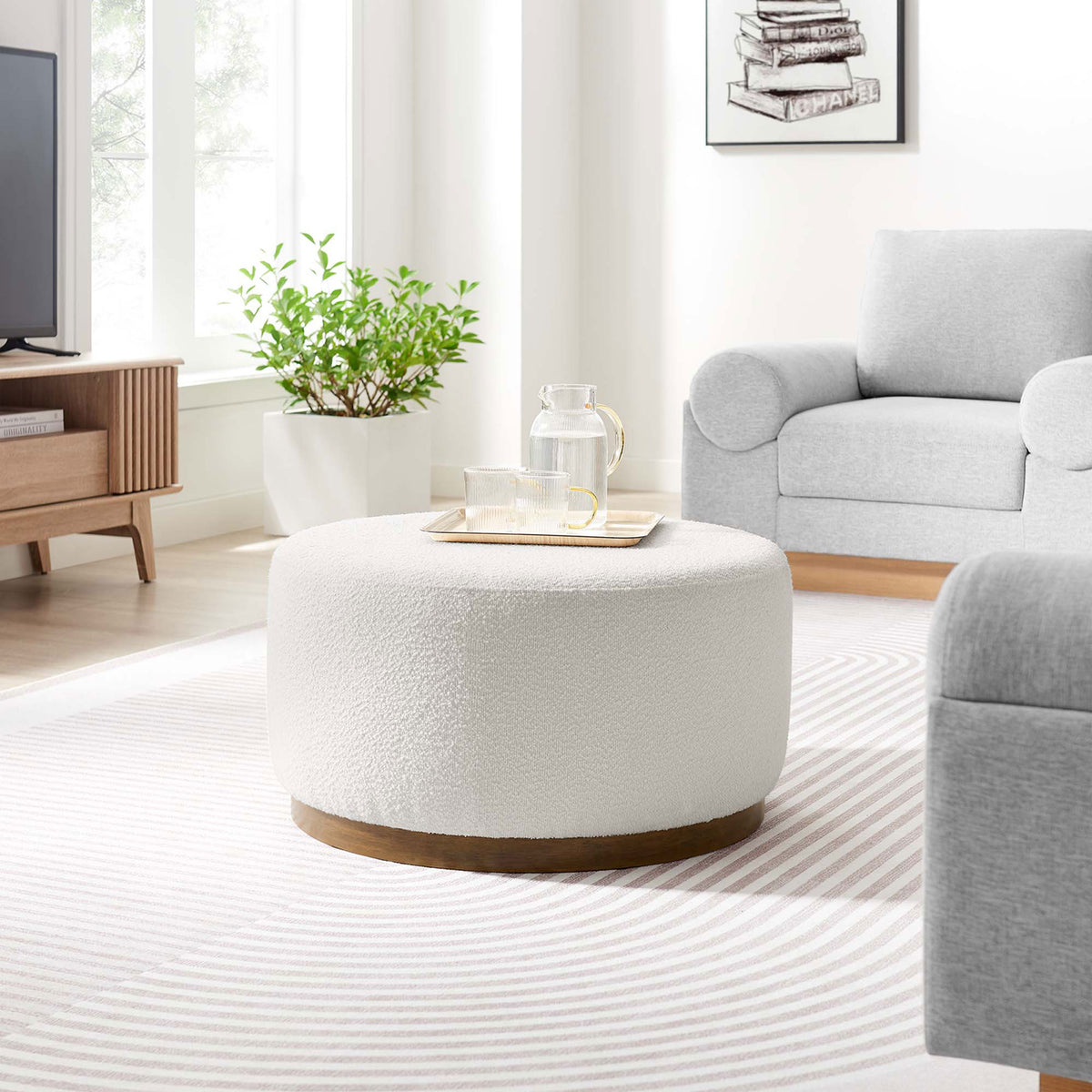 Cloud boucle ottoman styled in a bright living room with gray sofa and striped rug || EEI-6681-CLO-WAL || front_angle_room