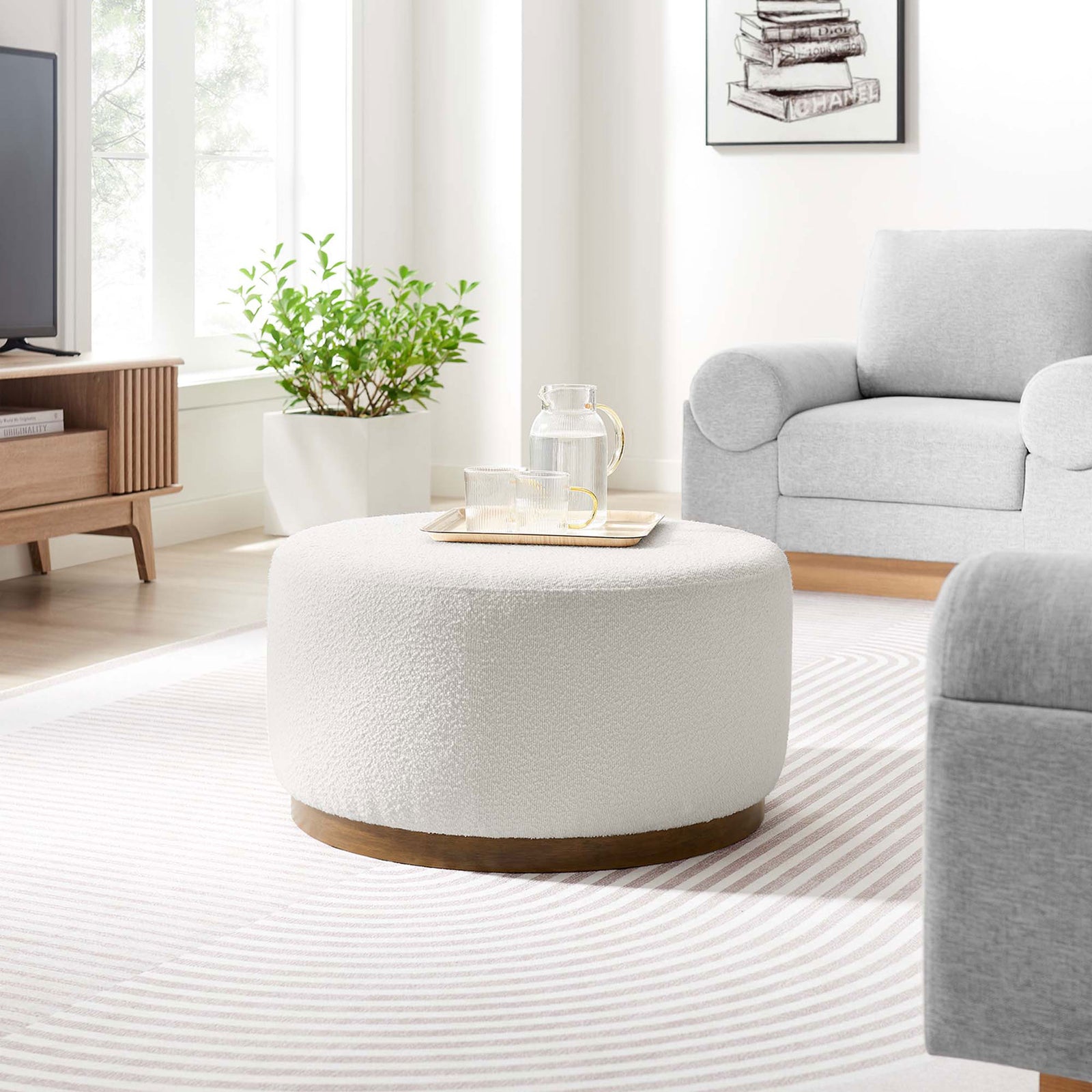 Cloud boucle ottoman styled in a bright living room with gray sofa and striped rug || EEI-6681-CLO-WAL || front_angle_room