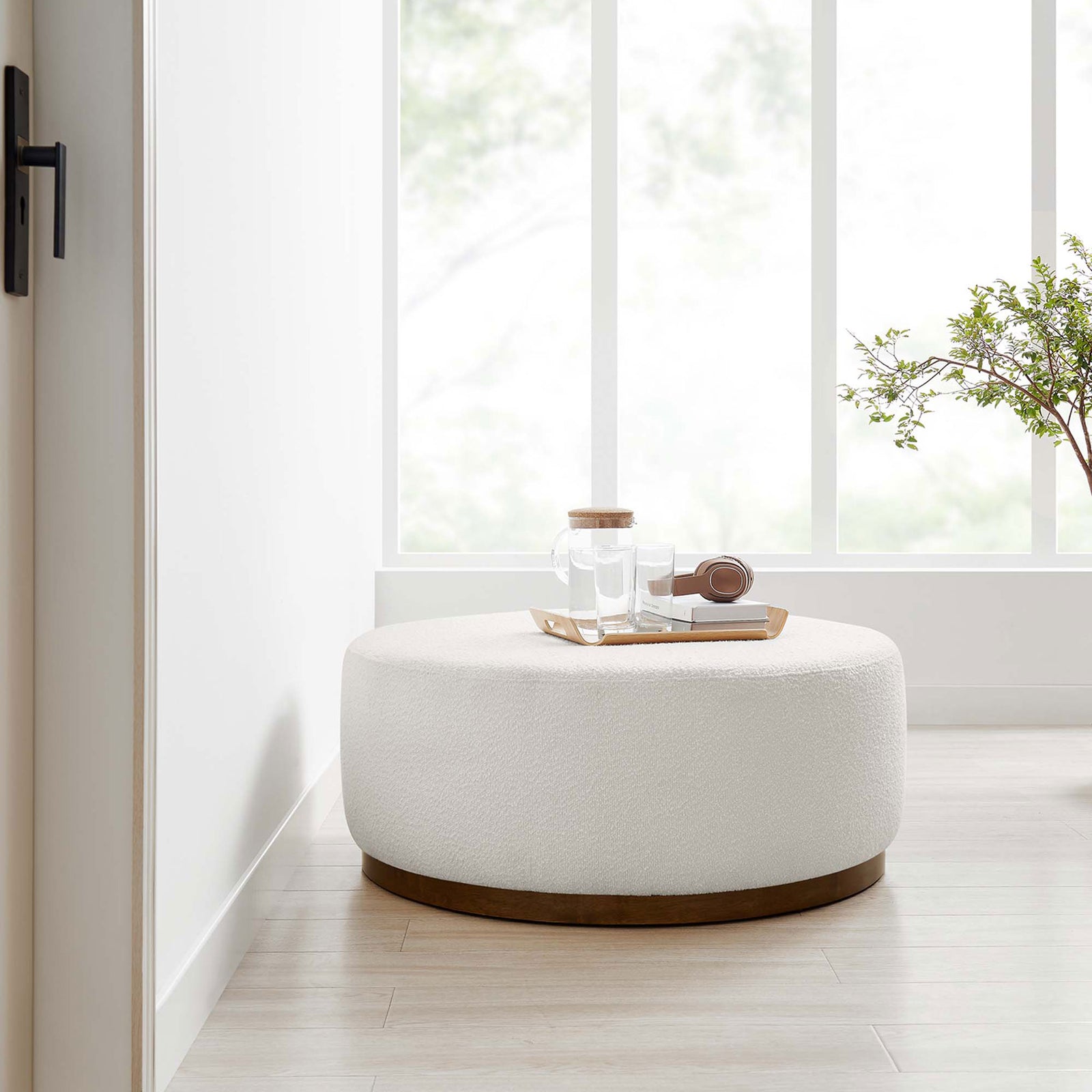 Large cloud boucle ottoman styled in a sunlit nook with tray and headphones ready to relax || EEI-6682-CLO-WAL || front_angle_room
