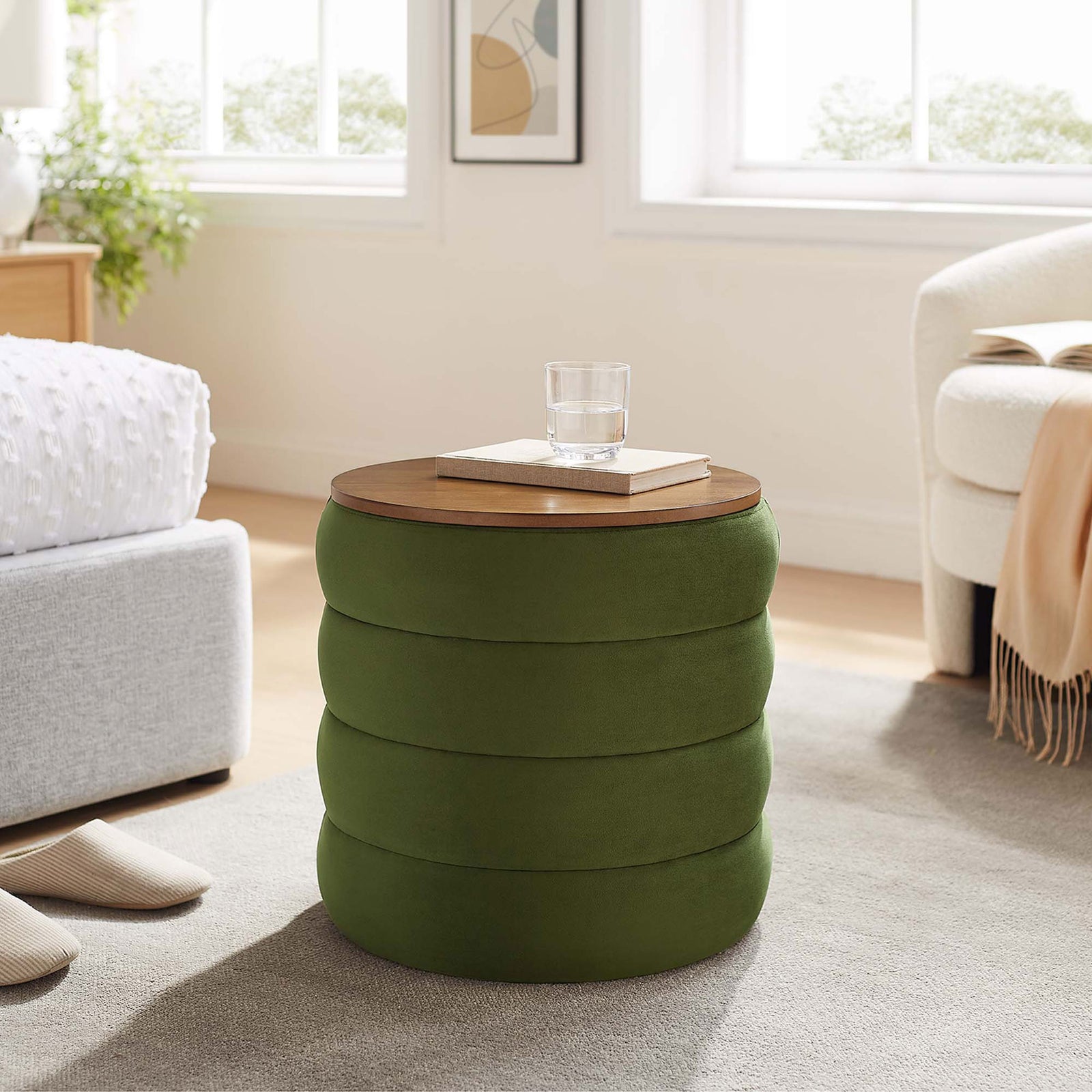 Mezzo moss green storage ottoman used as a bedside accent table with books and glassware on the lid || EEI-6684-MOG || front_angle_room
