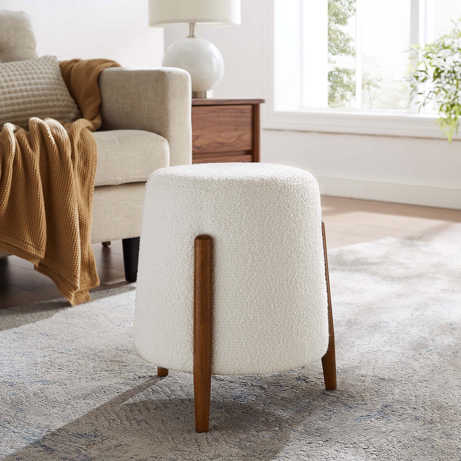 Cloud boucle ottoman adds soft texture beside a cozy sofa in a bright, relaxed living room || EEI-6686-CLO || side_room