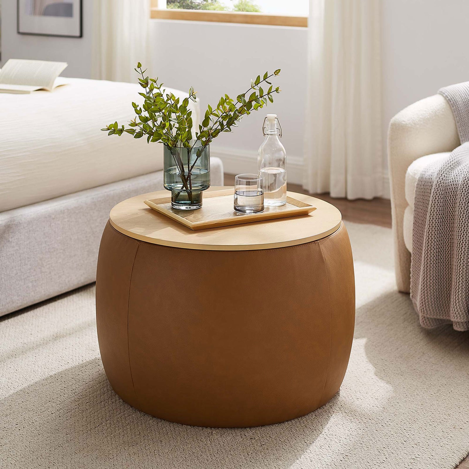 Perla tan storage ottoman used as a bedside table, adding warm texture next to the bed and chair || EEI-6687-TAN || front_angle_room