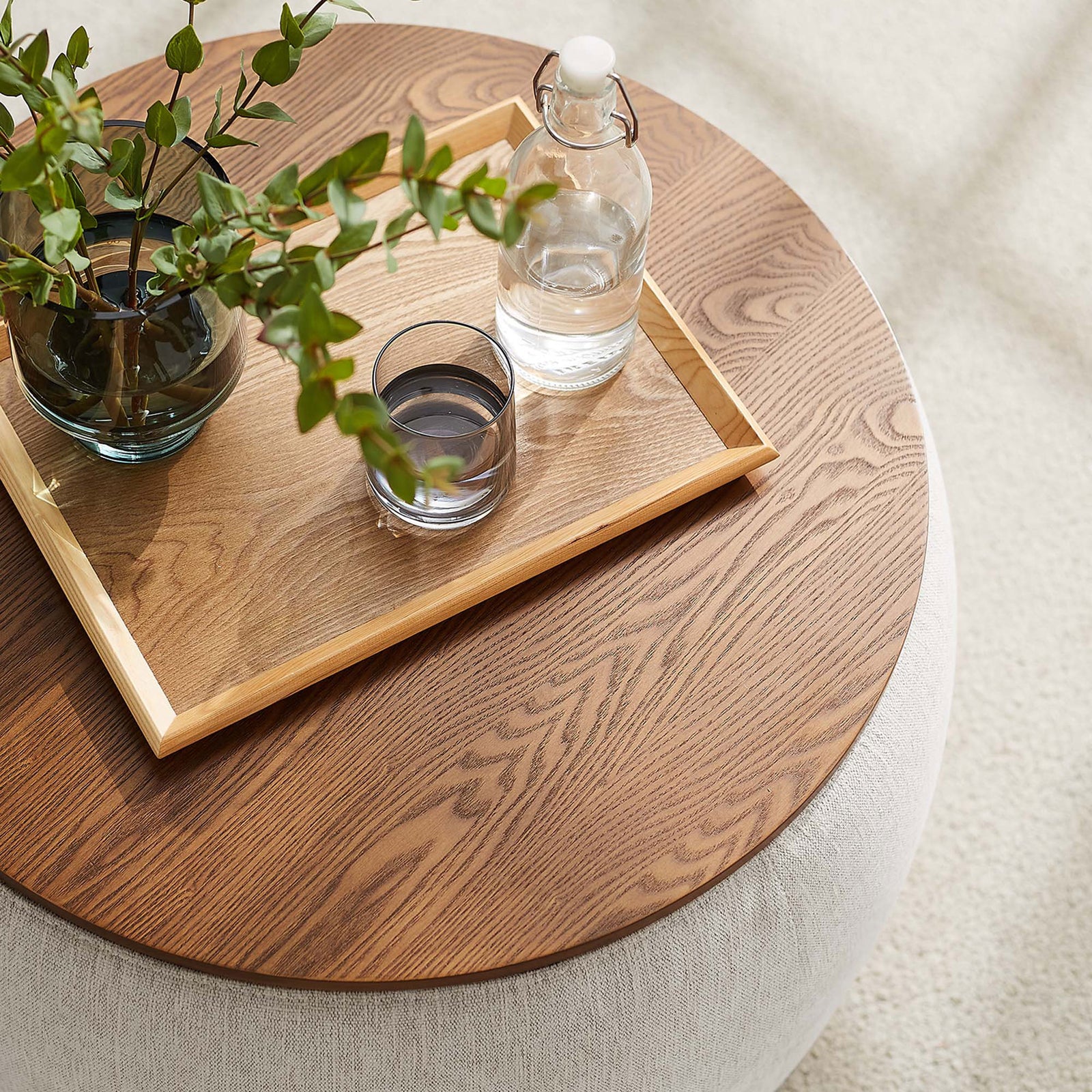 Perla ivory storage ottoman styled as a coffee table with tray, glassware, and greenery || EEI-6688-HEI || detail_room