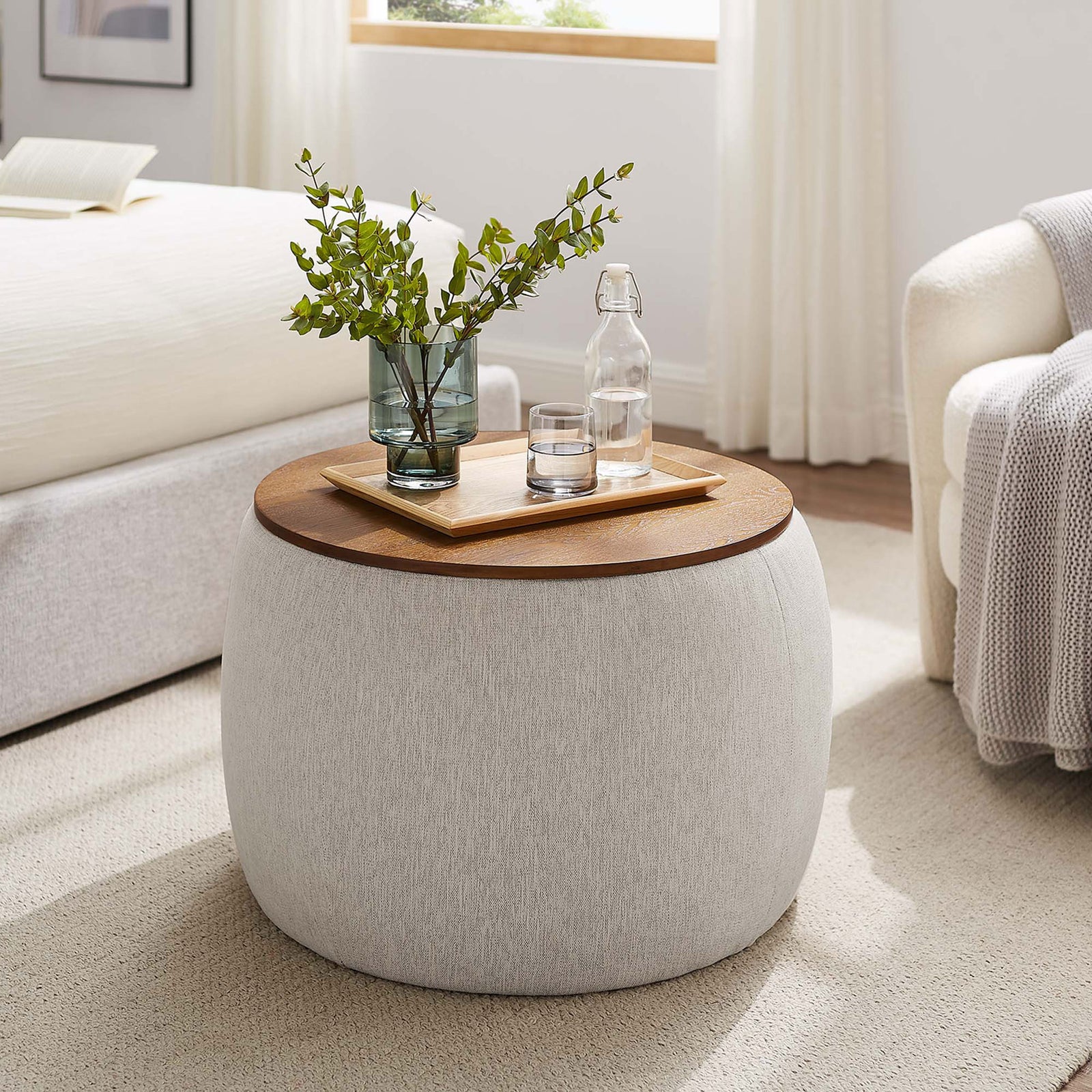 Ivory Perla storage ottoman used as a bedside table with tray, water carafe, and leafy vase || EEI-6688-HEI || front_angle_room