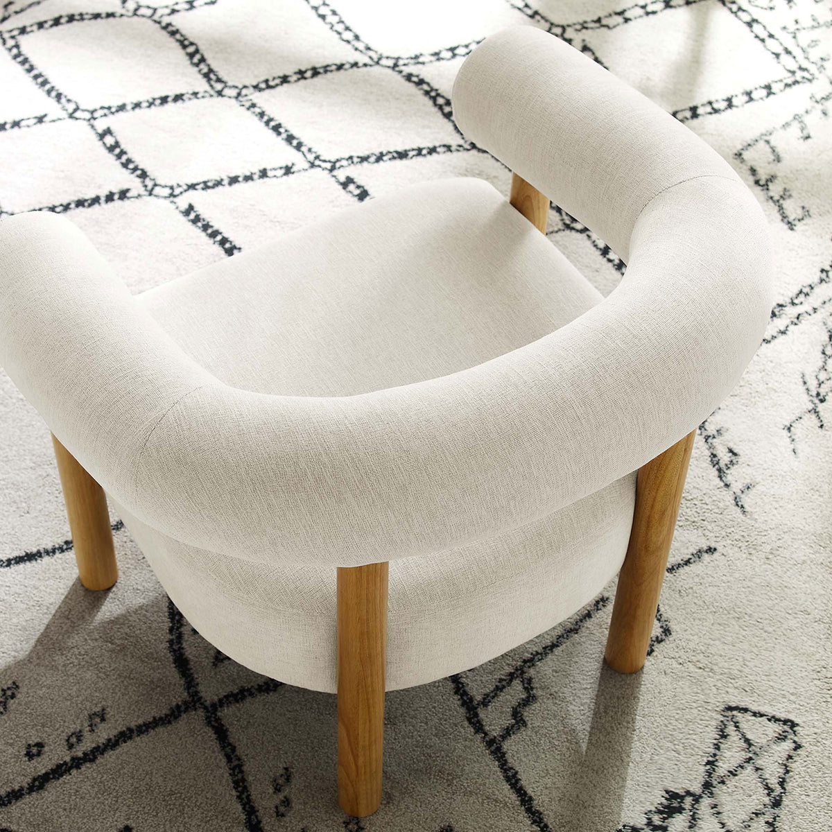Textured ivory fabric and curved backrest bring soft geometry to layered, modern living spaces || EEI-6689-IVO-NAT || detail_room