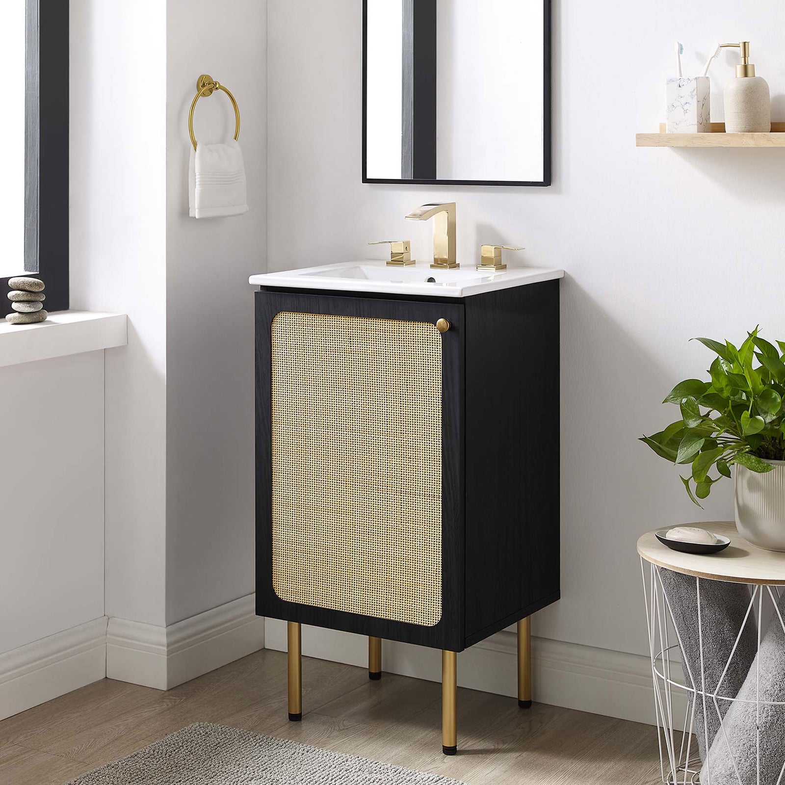 Chic black vanity with rattan door and brass accents elevates a bright, modern bathroom || EEI-6691-BLK-WHI || front_angle_room