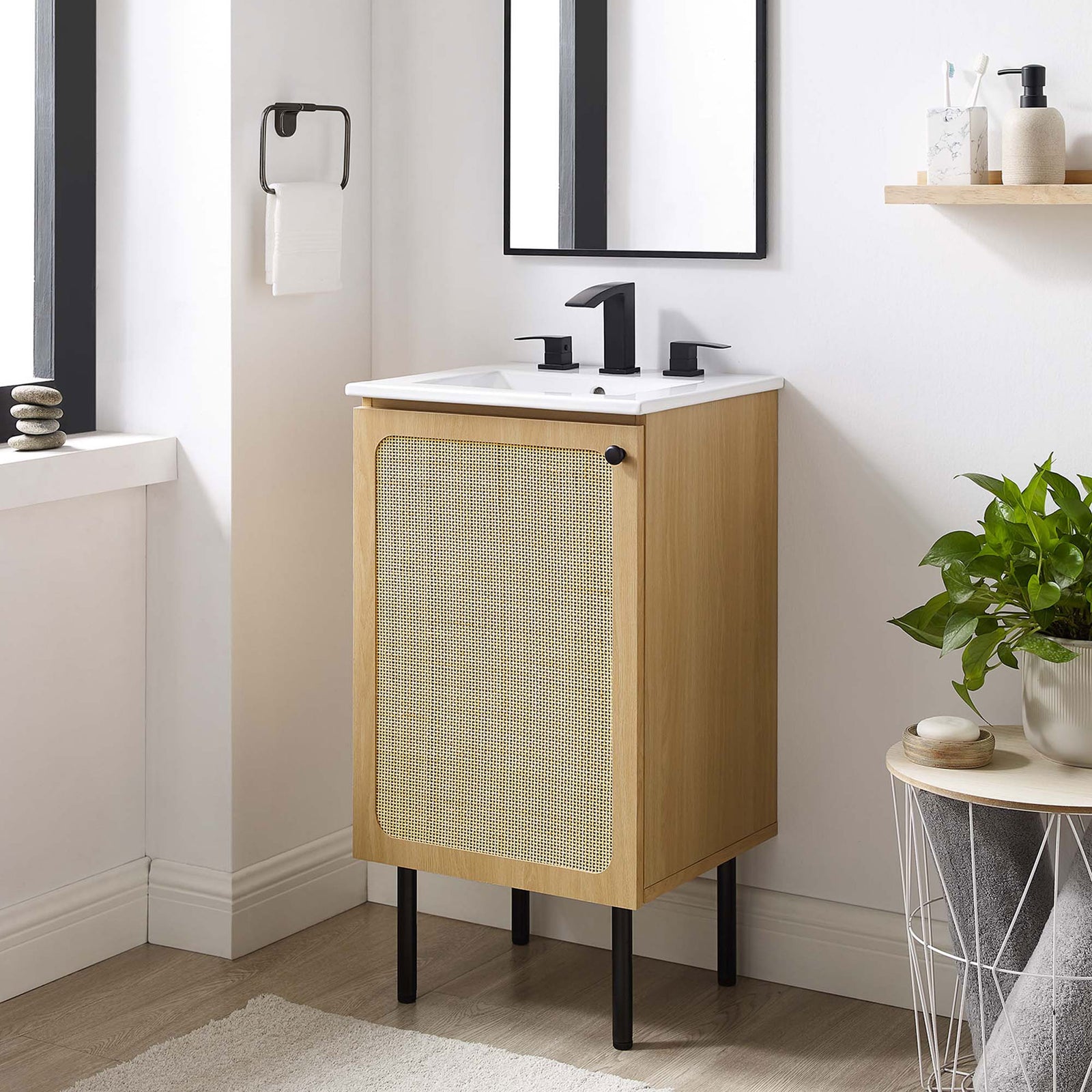 Warm oak vanity styles beautifully in a bright bath with its woven door and clean lines || EEI-6691-OAK-WHI || front_angle_room