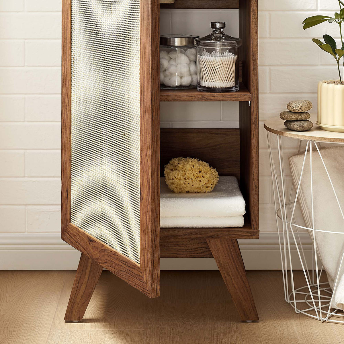 Adjustable shelves keep towels and toiletries organized behind the woven rattan door. || EEI-6711-WAL-WHI || storage_open_room