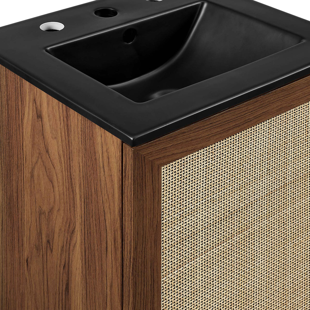 Cane rattan door framed by walnut grain beside the matte black sink rim || EEI-6712-WAL-BLK || detail_studio