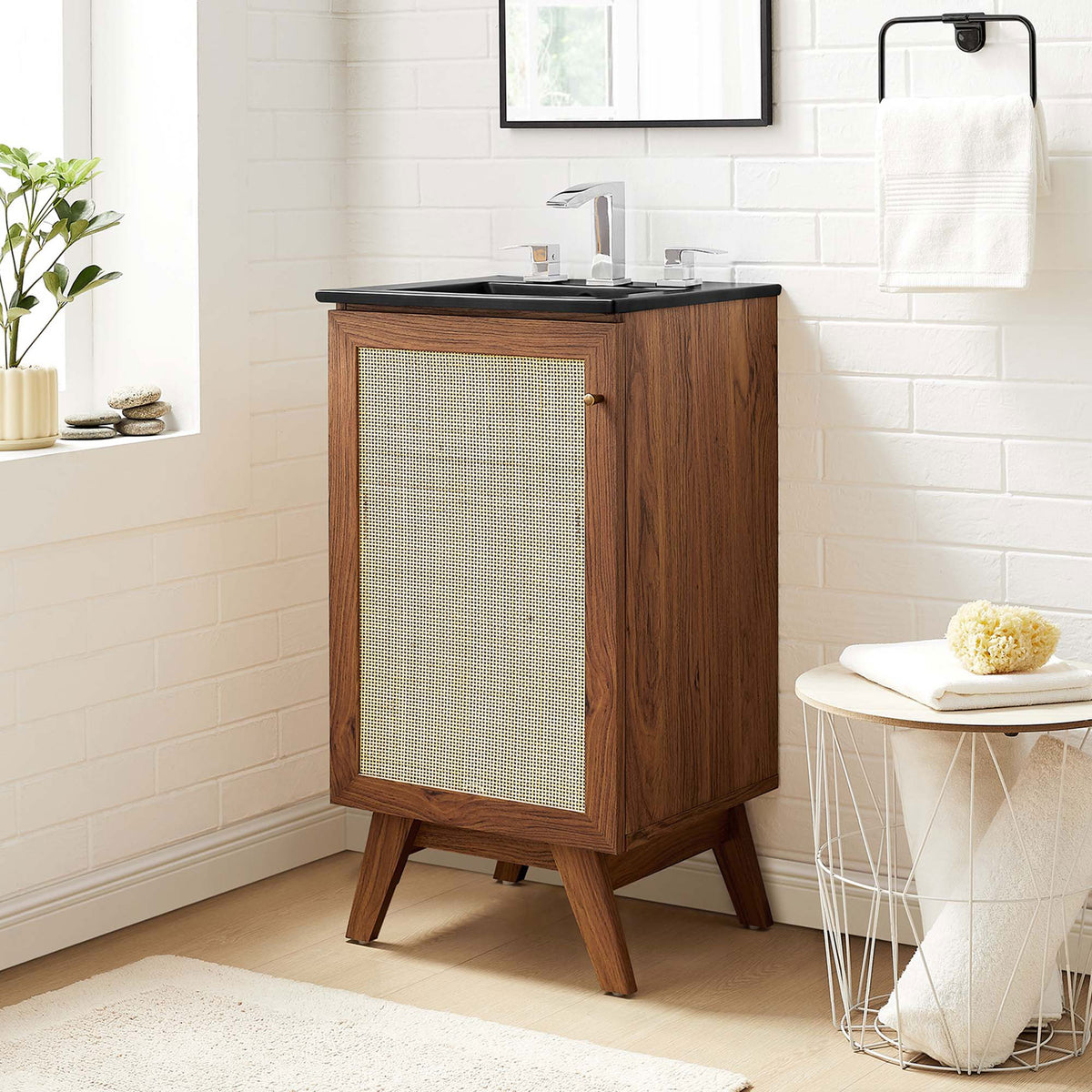 Compact walnut vanity with cane door and matte black sink adding warmth and contrast || EEI-6712-WAL-BLK || front_angle_room