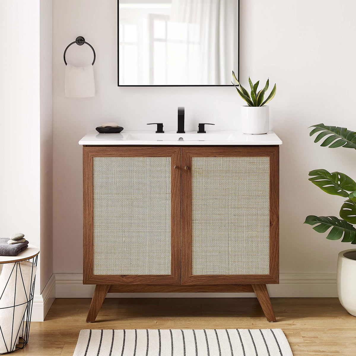 Warm walnut tones and airy caning elevate this vanity in a bright, inviting bath || EEI-6717-WAL-WHI || front_room