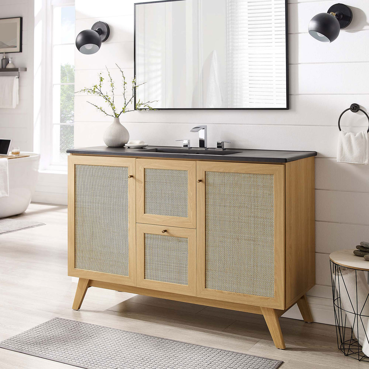Warm oak vanity with rattan fronts and black sink elevates the bath with organic style || EEI-6720-OAK-BLK || front_room
