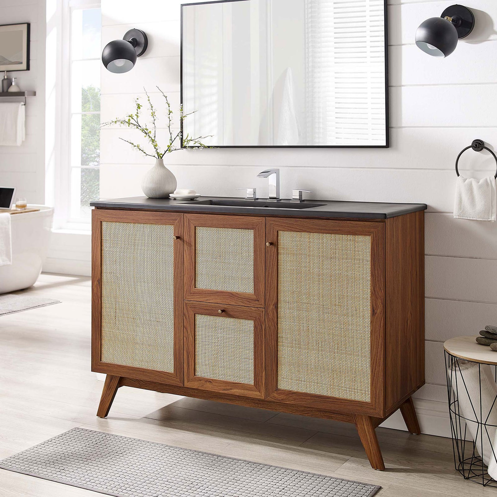 Crisp, modern vanity anchors the bath with warm walnut, rattan panels, and a sleek black sink. || EEI-6720-WAL-BLK || front_room