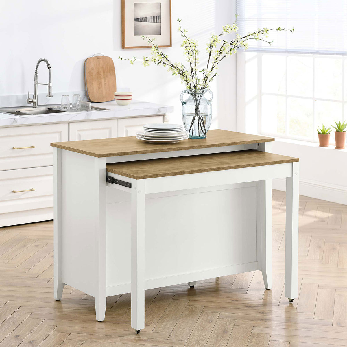 Kitchen island with pull out table extended and set with plates and drinks for casual kitchen dining || EEI-6727-OAK-WHI || back_angle_converted_room