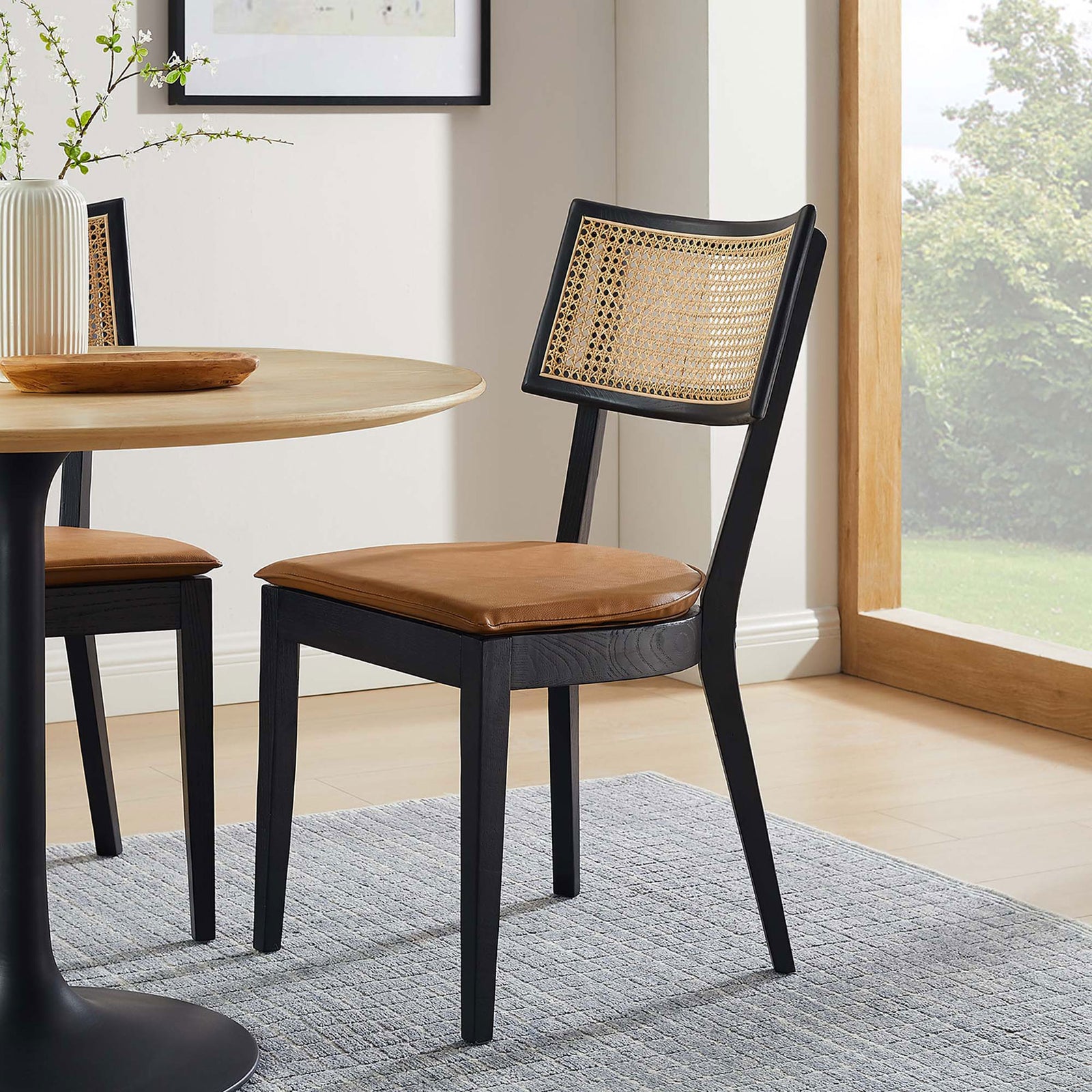 Black wood dining chair with tan vegan leather seat and rattan back in a modern breakfast nook || EEI-6732-BLK-TAN || front_angle_room