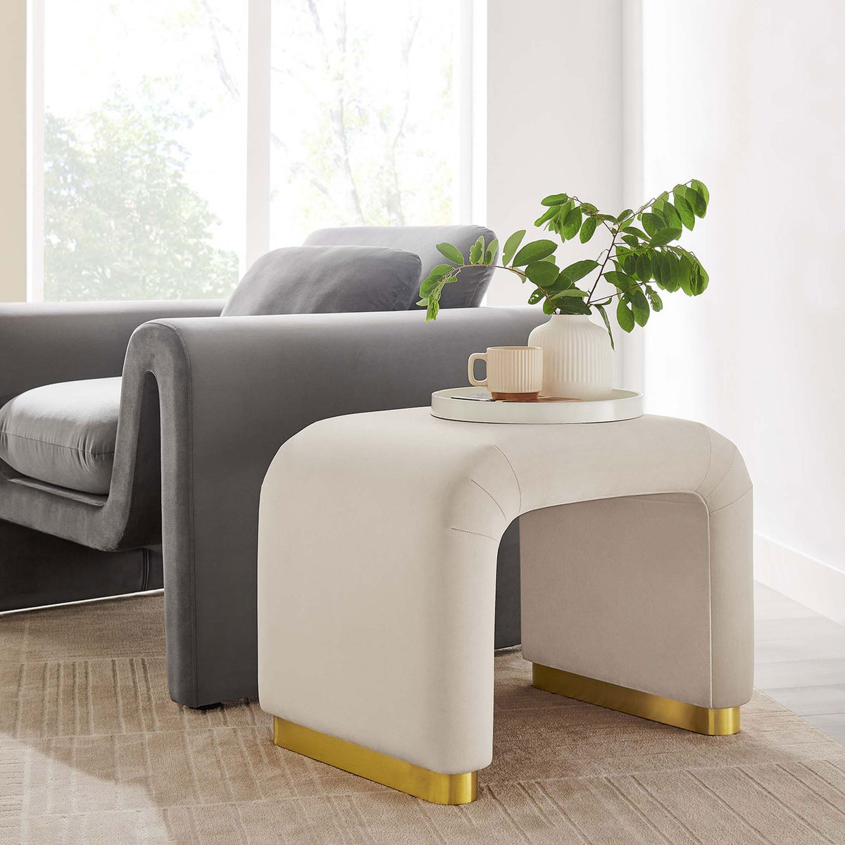 Warm almond velvet contrasts beautifully with the gleam of the brass-finished base || EEI-6733-BRA-ALM || front_angle_room