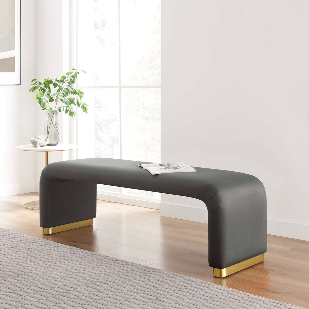 Chic gray velvet bench anchors the room with its smooth waterfall form and warm brass foot accents || EEI-6734-BRA-STG || front_angle_room
