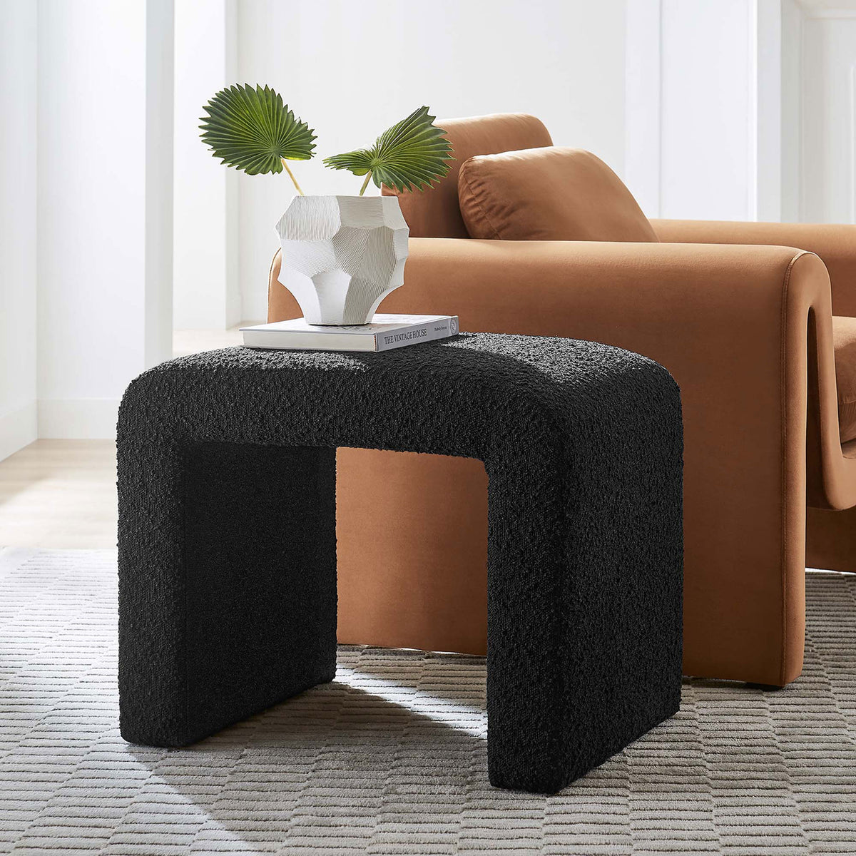 Textured boucle stool brings soft curves and rich depth beside contemporary seating || EEI-6737-BLK || front_angle_room