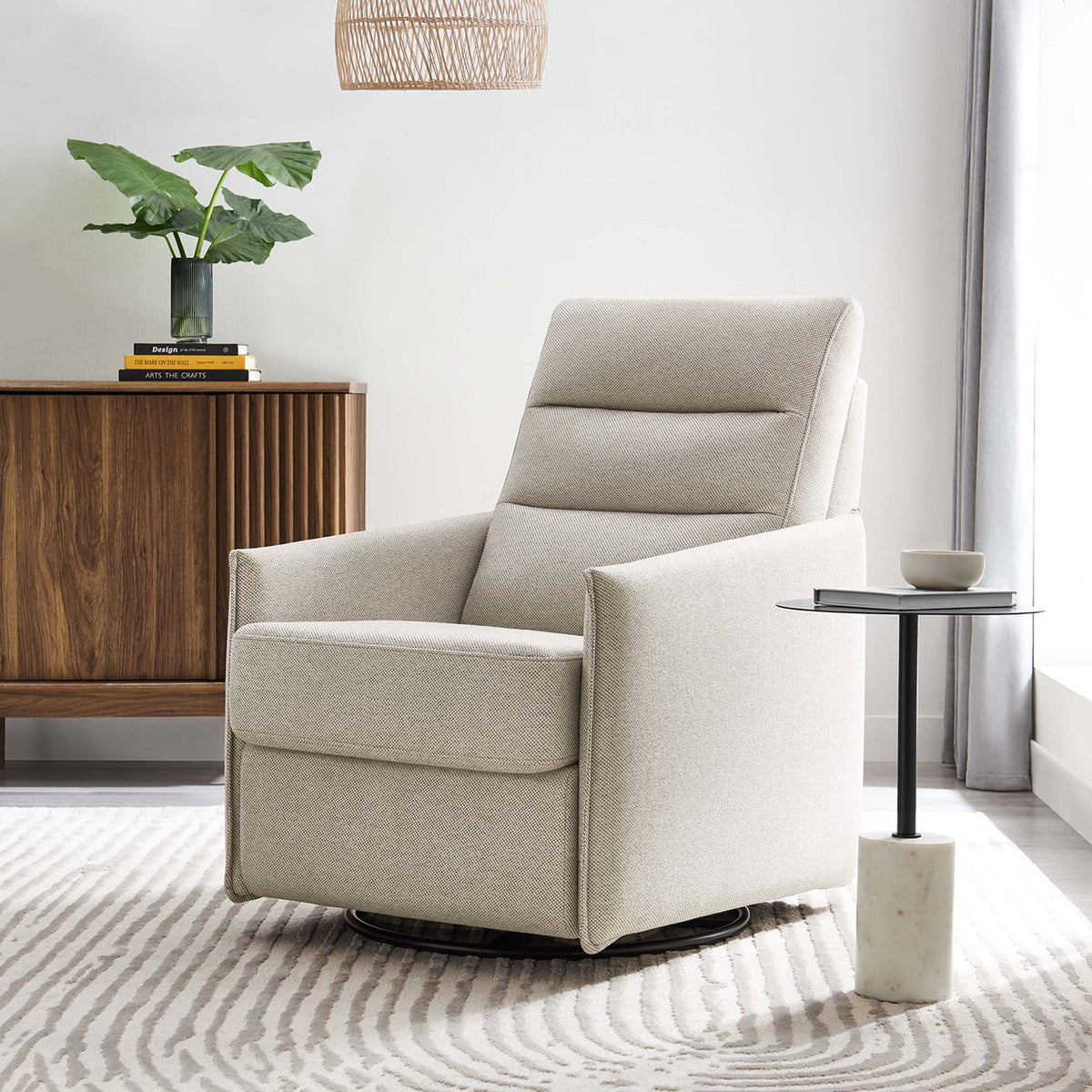 Elevates any room with clean lines, oatmeal fabric, and effortless swivel and glide for relaxing moments || EEI-6738-OAT || front_angle_room