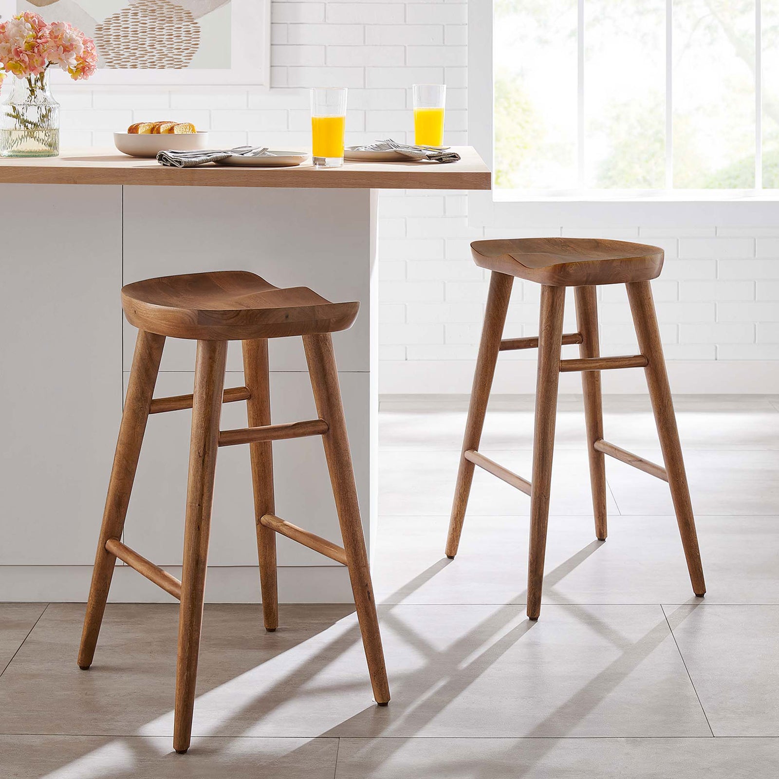 Two walnut counter stools bring warm wood tone and sculpted comfort to a modern kitchen island || EEI-6739-WAL || front_angle_multi_room