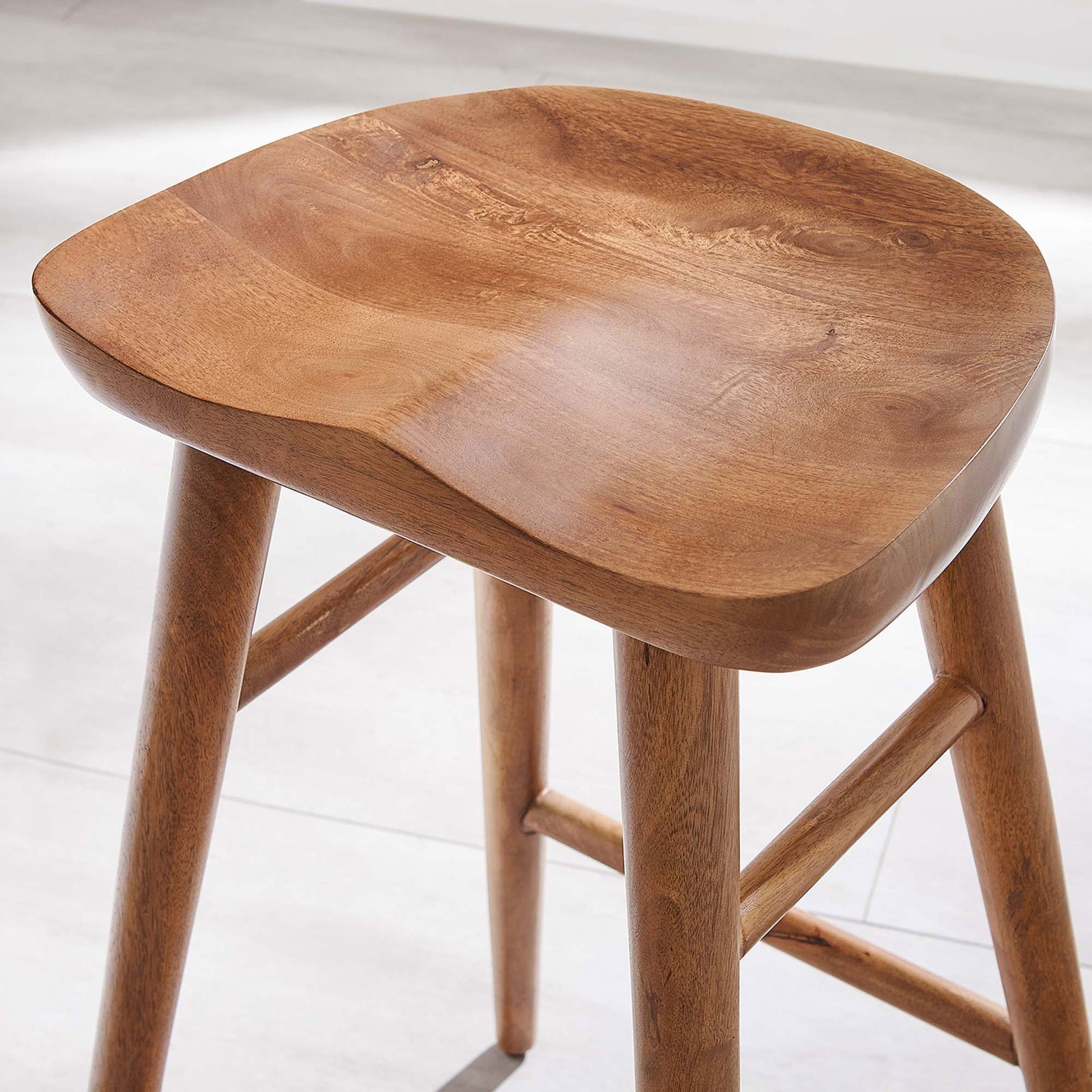 Walnut wood seat shows smooth curves and natural grain in a bright kitchen setting || EEI-6739-WAL || detail_room
