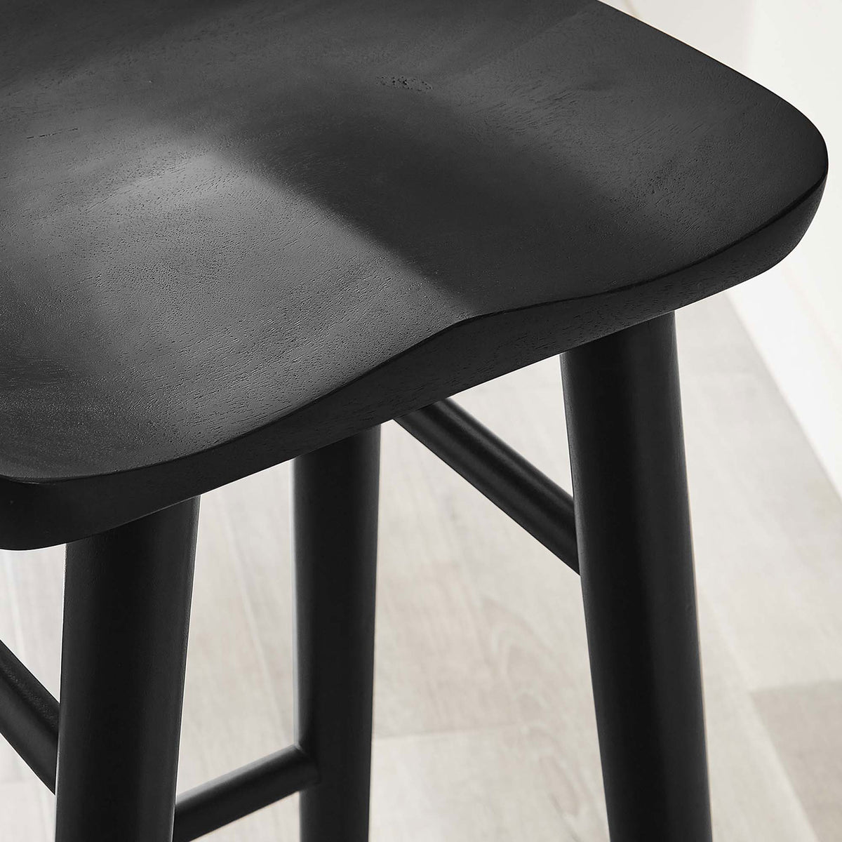 Sculpted black wood seat adds organic texture beside a bar-height counter. || EEI-6740-BLK || detail_room