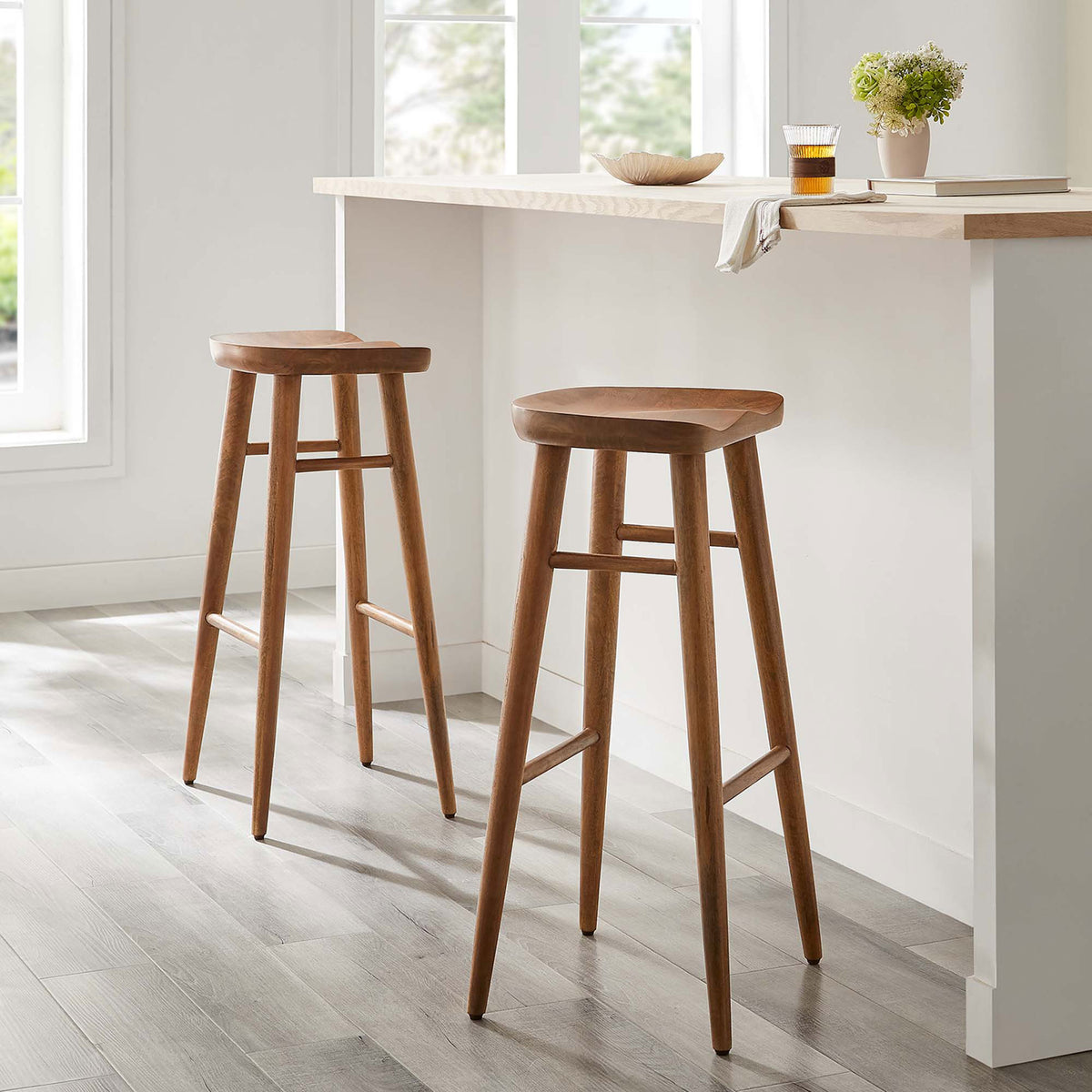 Two walnut bar stools offer sculpted comfort and warmth at a sleek kitchen counter || EEI-6740-WAL || front_angle_multi_room