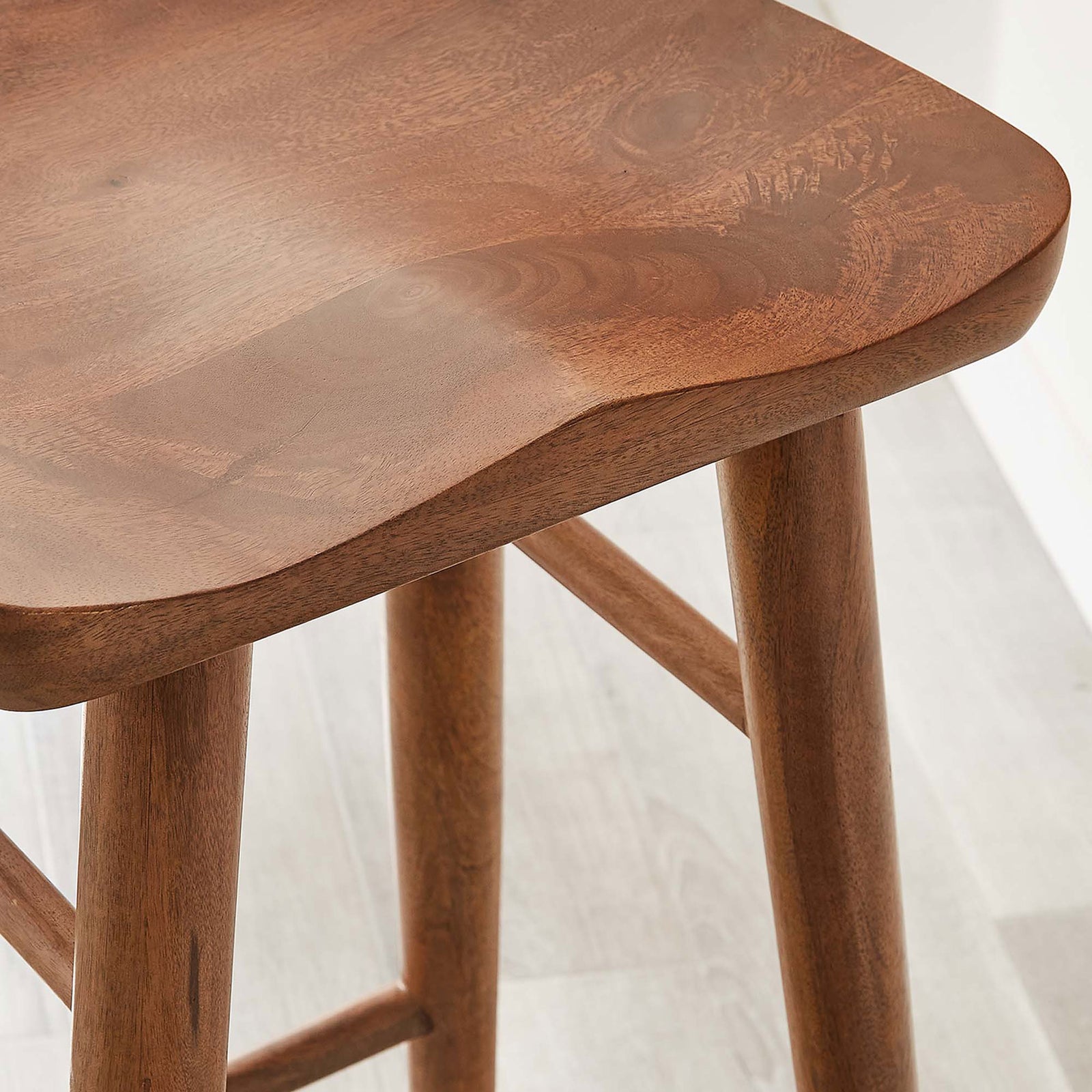 Walnut wood surface displays fine grain and smooth sculpting in a bright bar space || EEI-6740-WAL || detail_room