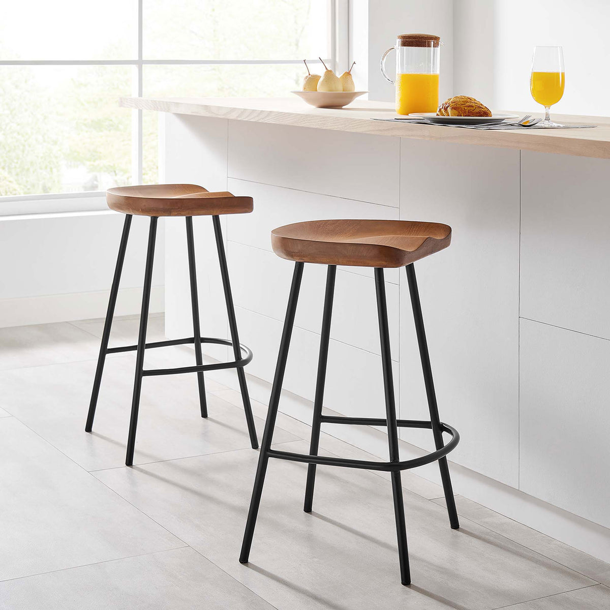 Pair of counter stools adds warm wood tone and airy black lines to a bright modern kitchen || EEI-6741-WAL || front_angle_multi_room