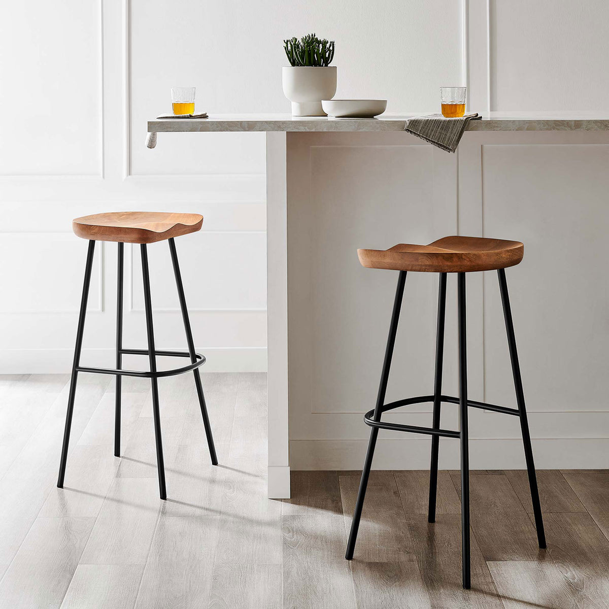 Pair of bar stools brings warm wood and crisp black accents to a refined dining nook || EEI-6742-WAL || front_angle_multi_room