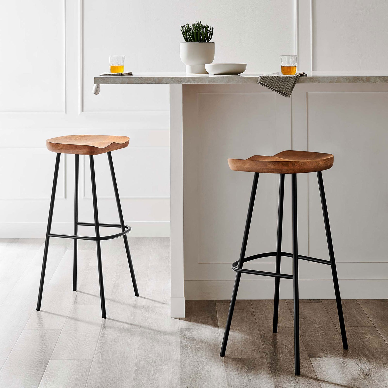 Pair of bar stools brings warm wood and crisp black accents to a refined dining nook || EEI-6742-WAL || front_angle_multi_room