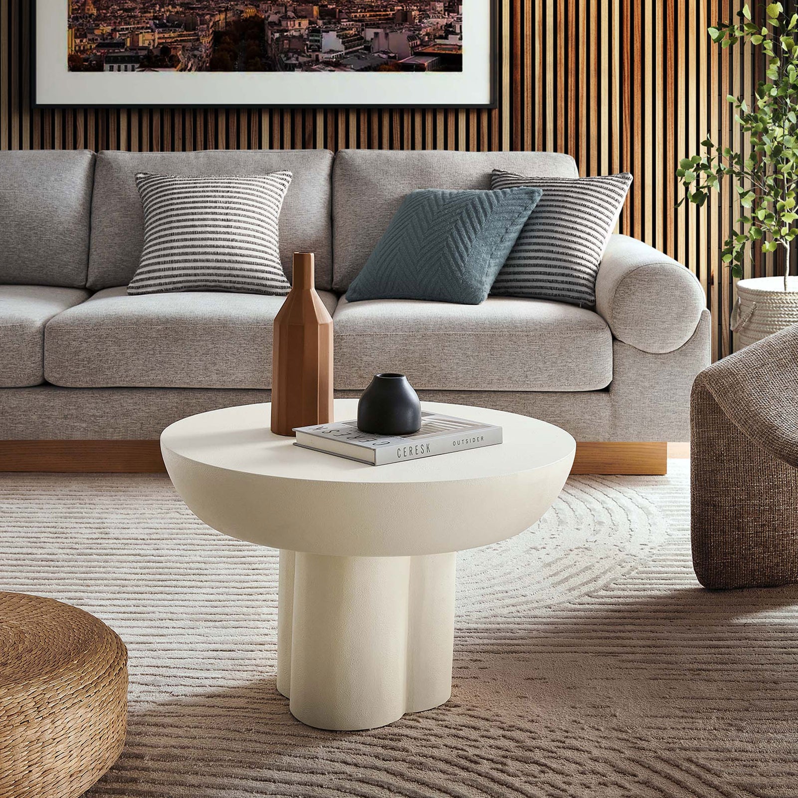 Statement round white coffee table with trefoil pedestal anchors a stylish lounge space || EEI-6760-WHI || front_angle_room