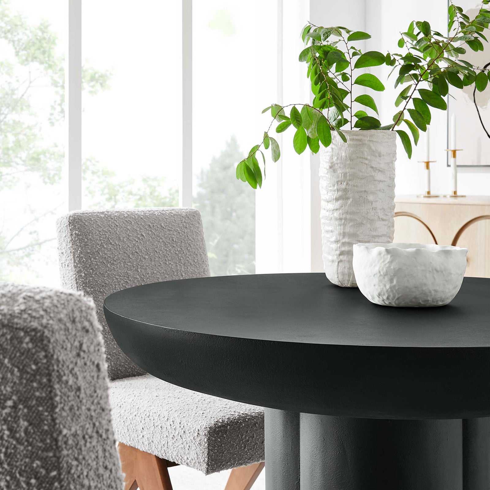 Styled black round tabletop paired with textured chairs in a bright dining nook || EEI-6762-BLK || detail_room