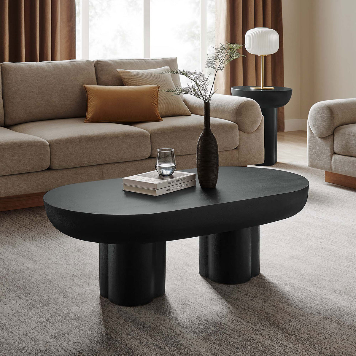 Striking black coffee table adds depth and contrast with its matte finish and rounded organic form || EEI-6763-BLK || front_angle_room