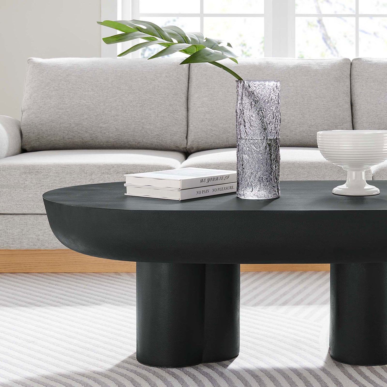 Elevates a neutral living room with its bold black silhouette and modern oval profile || EEI-6763-BLK || detail_room