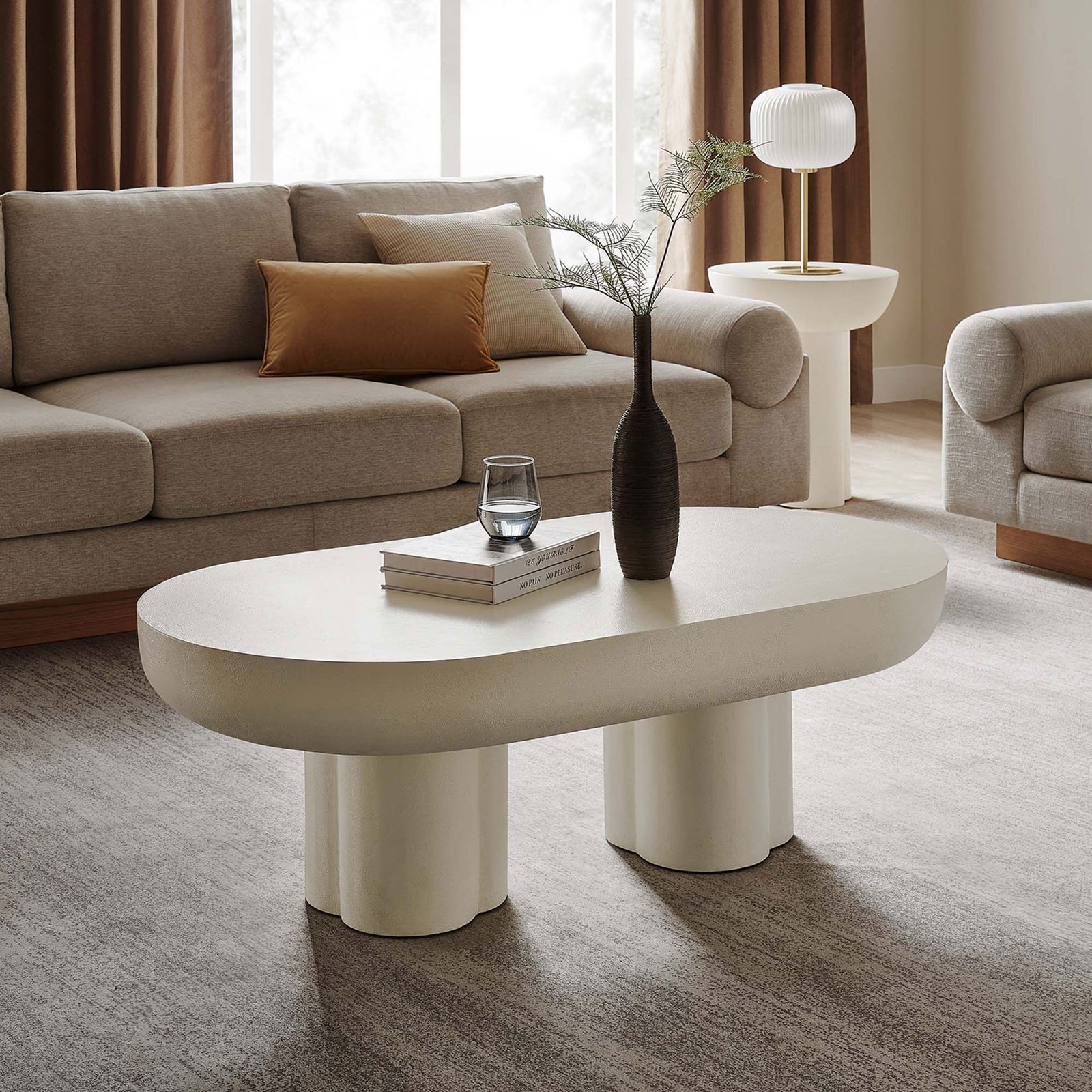 Statement coffee table brings mid-century inspired curves and a clean, minimalist presence || EEI-6763-WHI || front_angle_room
