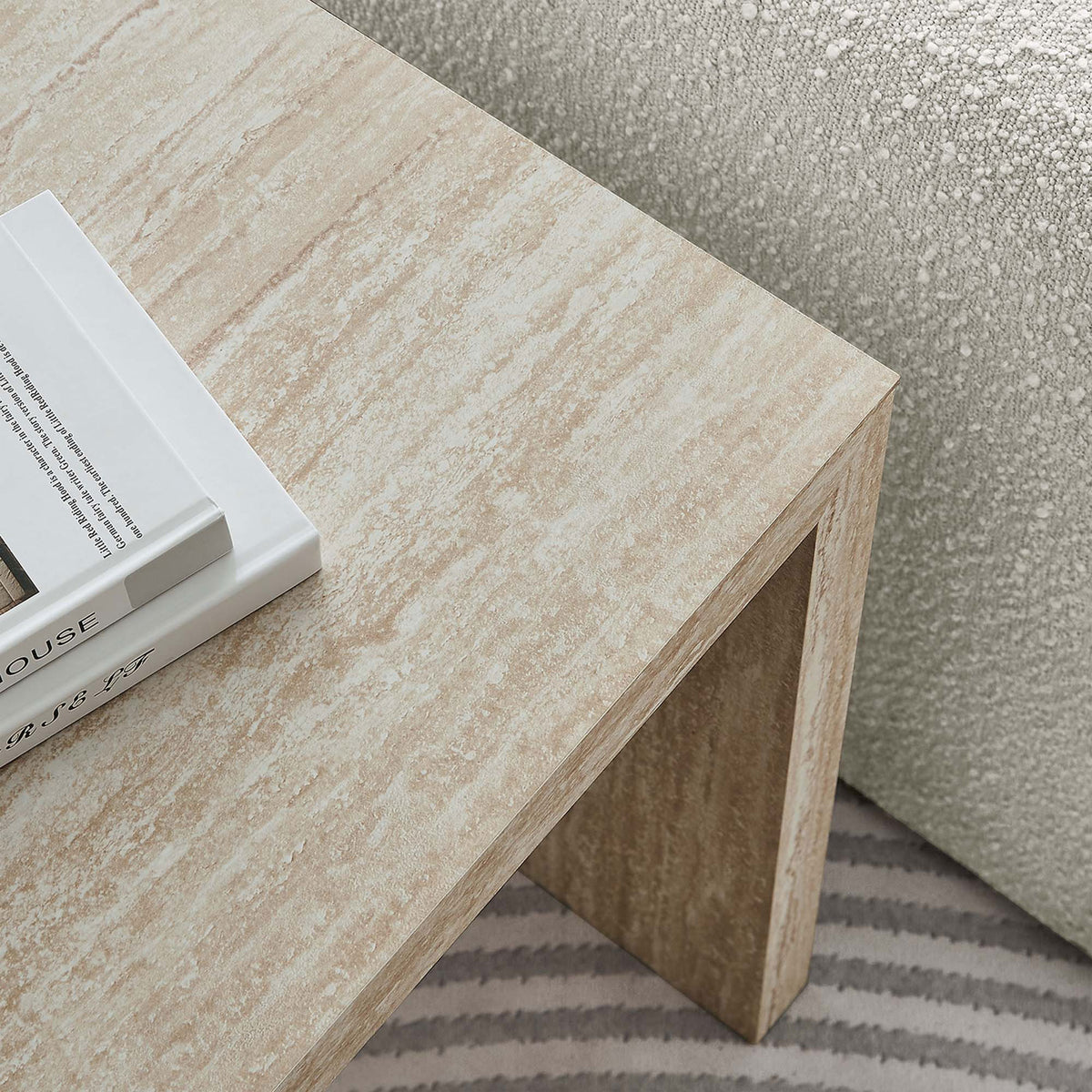 Faux travertine table styled beside a cozy sofa, perfect for keeping books and decor within easy reach || EEI-6772-TRA || detail_room
