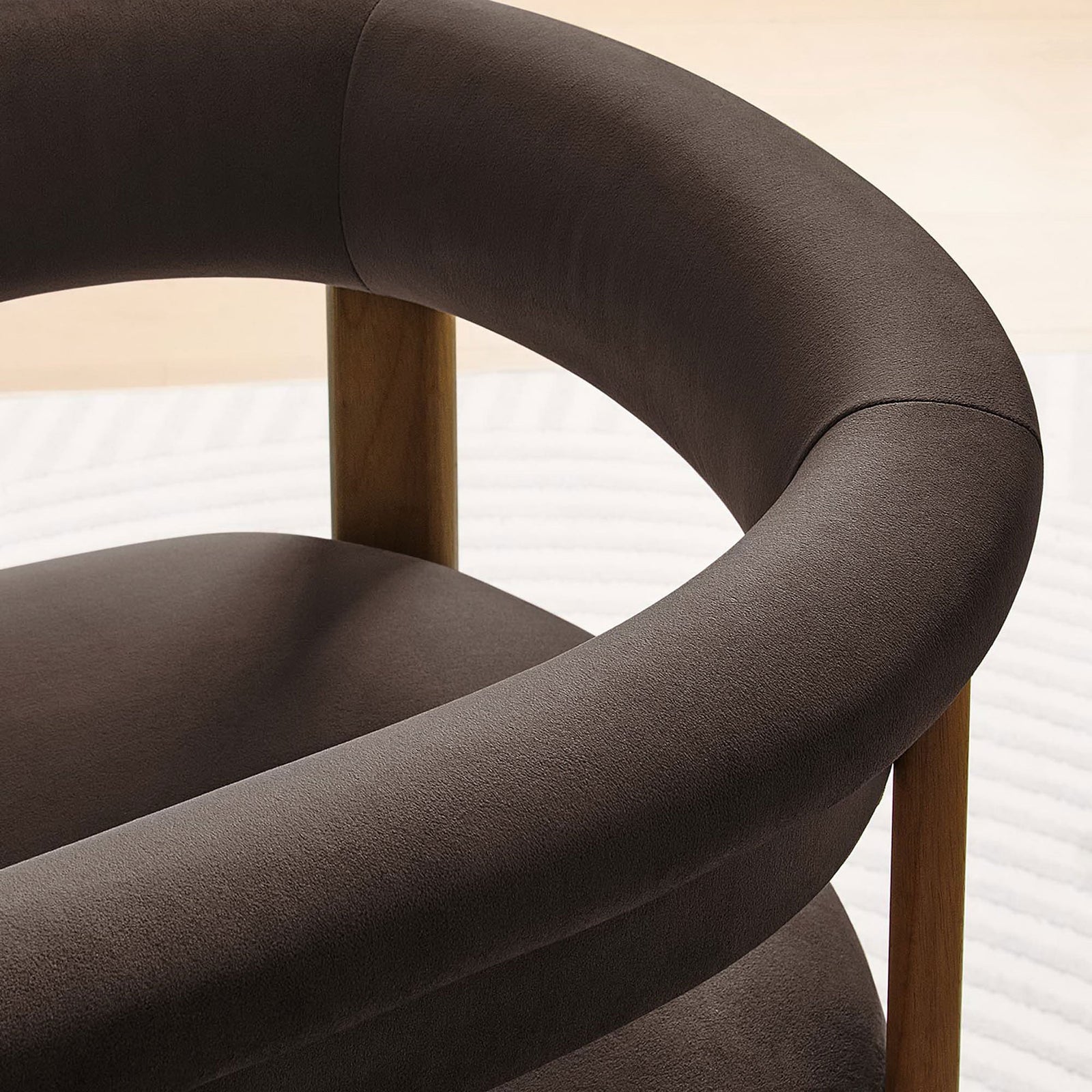 Soft chocolate brown performance velvet and curved backrest detail of the dining chair in a cozy room || EEI-6775-CHB-DBR || detail_room