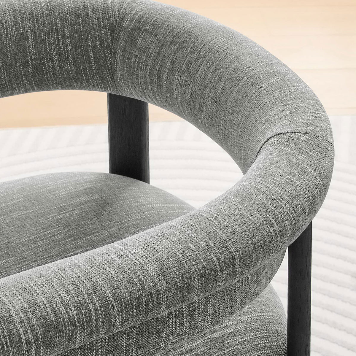 Barrel back gently curves around you, pairing textured gray fabric with airy, light-filled surroundings || EEI-6776-HEG-BLK || detail_room