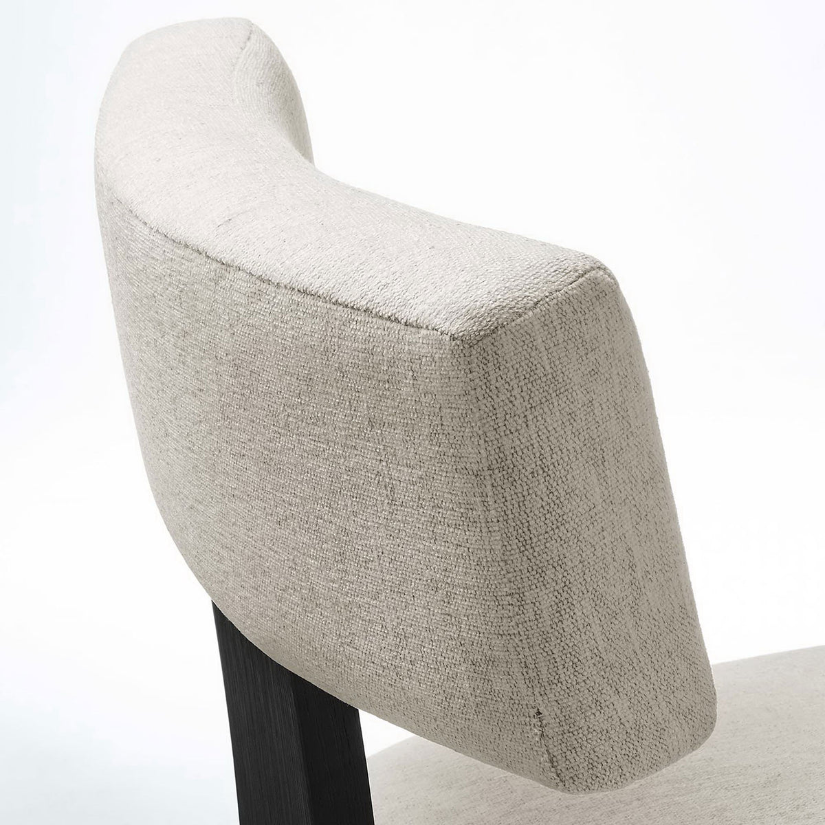 Close-up of soft textured ivory upholstery wrapping the curved backrest for tailored comfort || EEI-6777-HEI-BLK || detail_studio