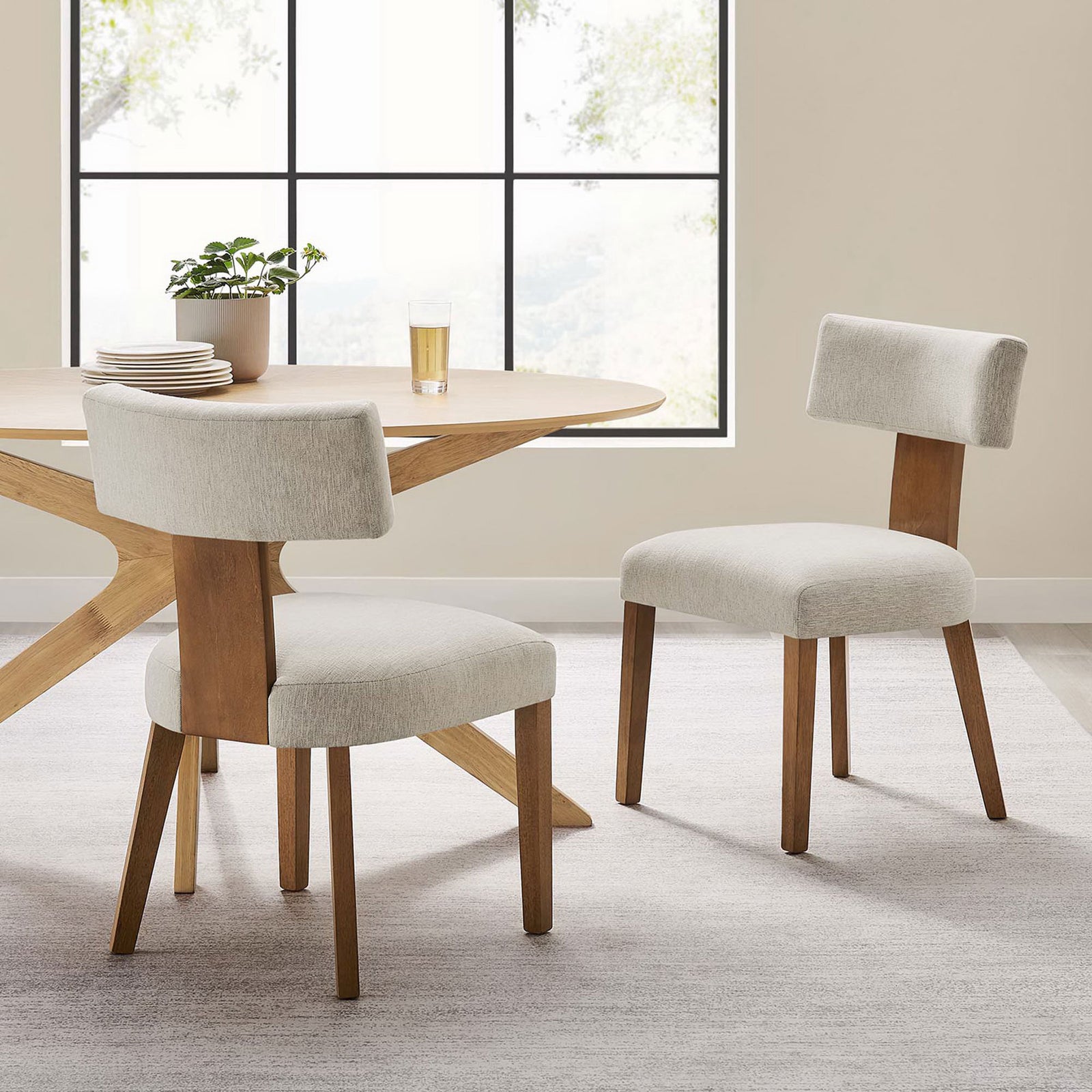 Set of two ivory dining chairs with deep brown wood frames around a contemporary table. || EEI-6777-HEI-DBR || front_angle_multi_room