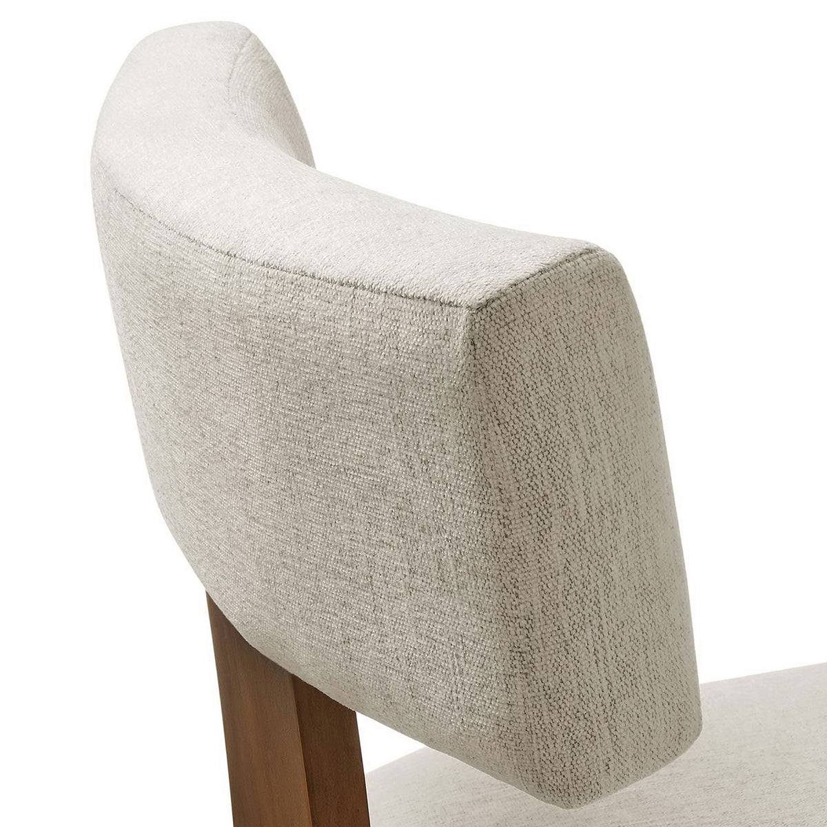 Textured ivory fabric and plush padding on the curved dining chair backrest. || EEI-6777-HEI-DBR || detail_studio