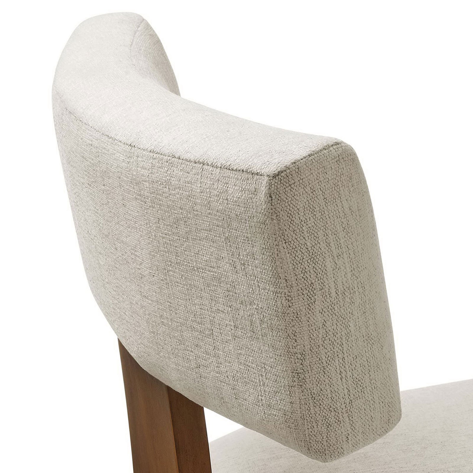 Textured ivory fabric and plush padding on the curved dining chair backrest. || EEI-6777-HEI-DBR || detail_studio