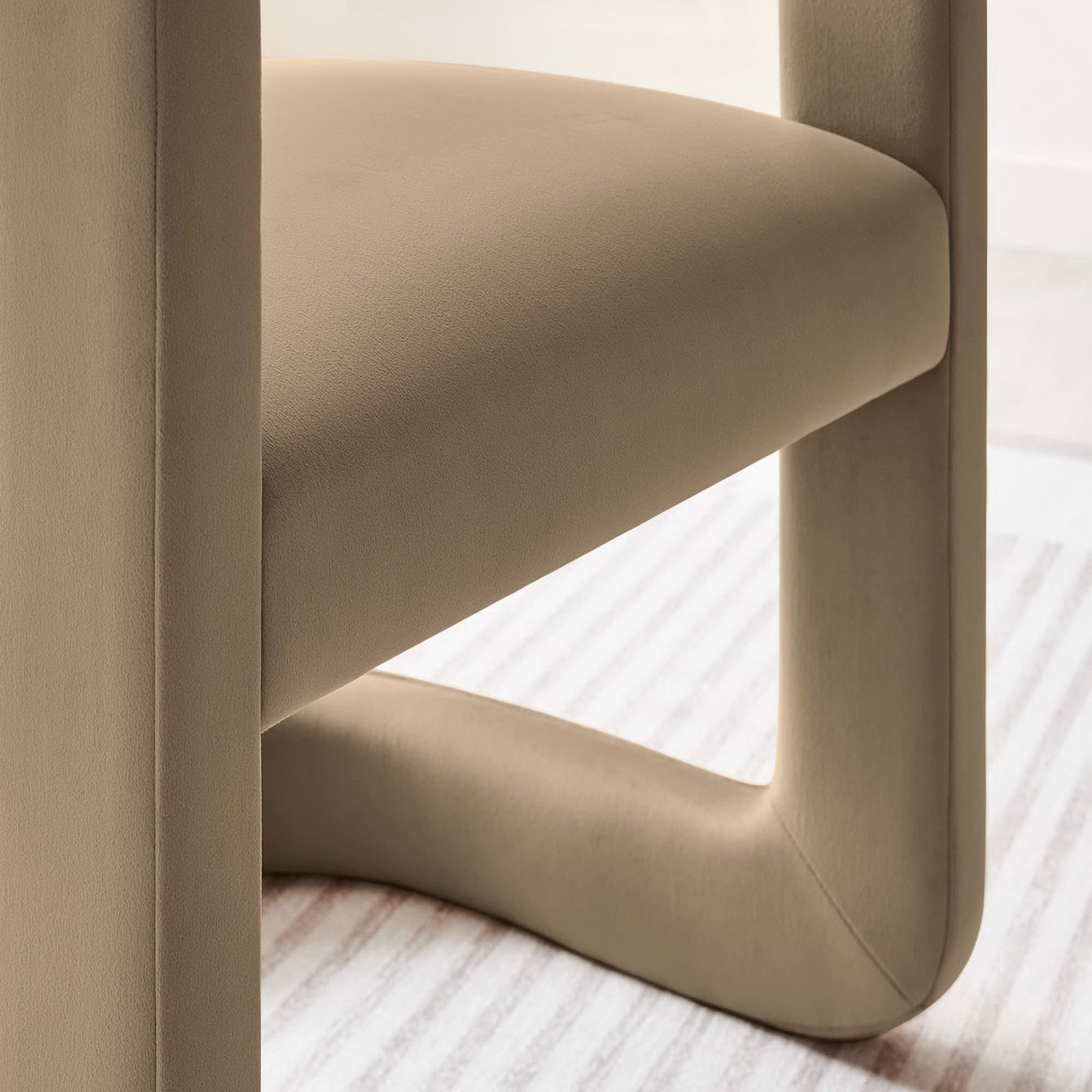 Sturdy base and plush seat showcase sleek curves wrapped in soft, stain-resistant taupe velvet. || EEI-6778-TAU || leg_room