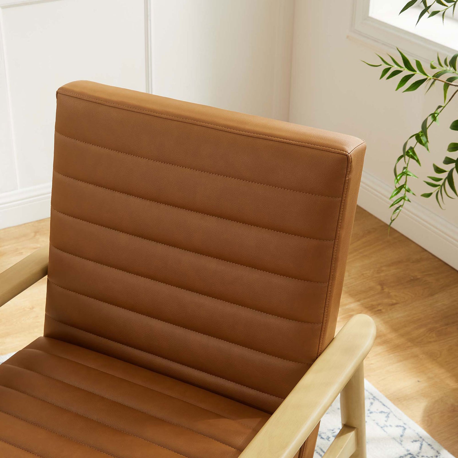 Warm tan upholstery adds inviting texture against the light wood frame in a cozy setting || EEI-6779-NAT-TAN || detail_room