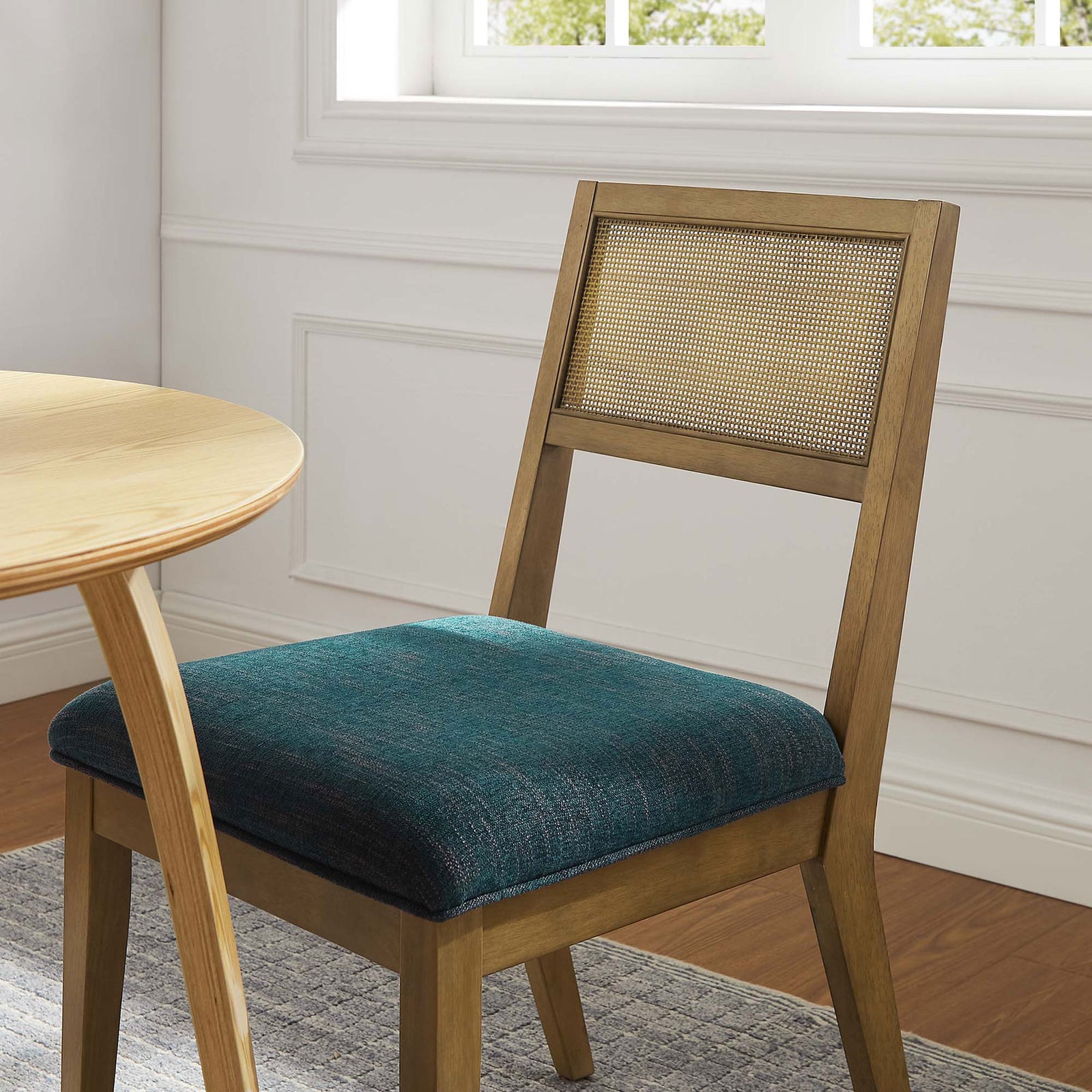 Nimba dining chair styled at a light wood table, adding rich blue texture to a bright modern dining nook || EEI-6781-FRO-HEA || front_angle_room