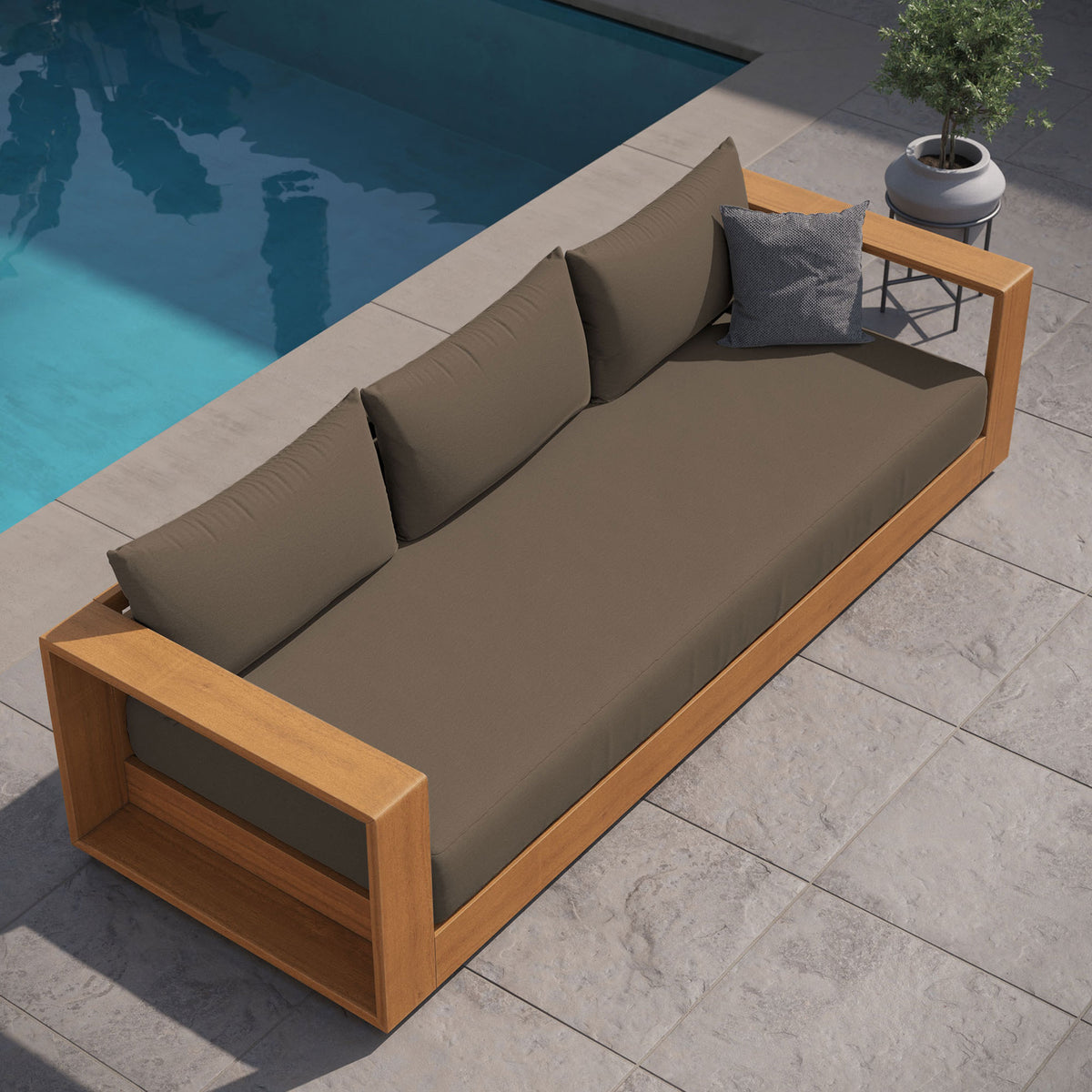 Tahoe outdoor sofa with cocoa cushions styled poolside on stone pavers for relaxed lounging. || EEI-6784-NAT-COA || front_angle_room