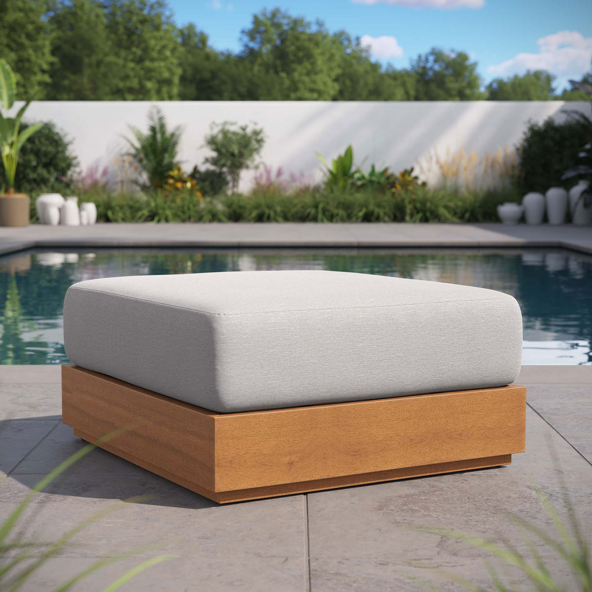 Light gray Tahoe ottoman anchors a modern poolside lounge with clean lines and warm wood tones || EEI-6785-NAT-LGR || front_angle_room