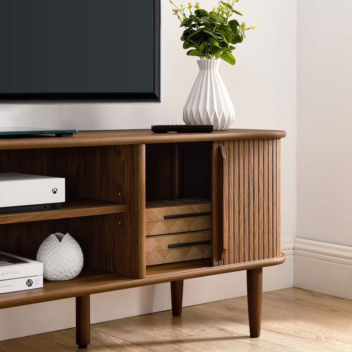 Open sliding door reveals neatly arranged storage inside the walnut TV stand || EEI-6795-WAL || storage_open_room