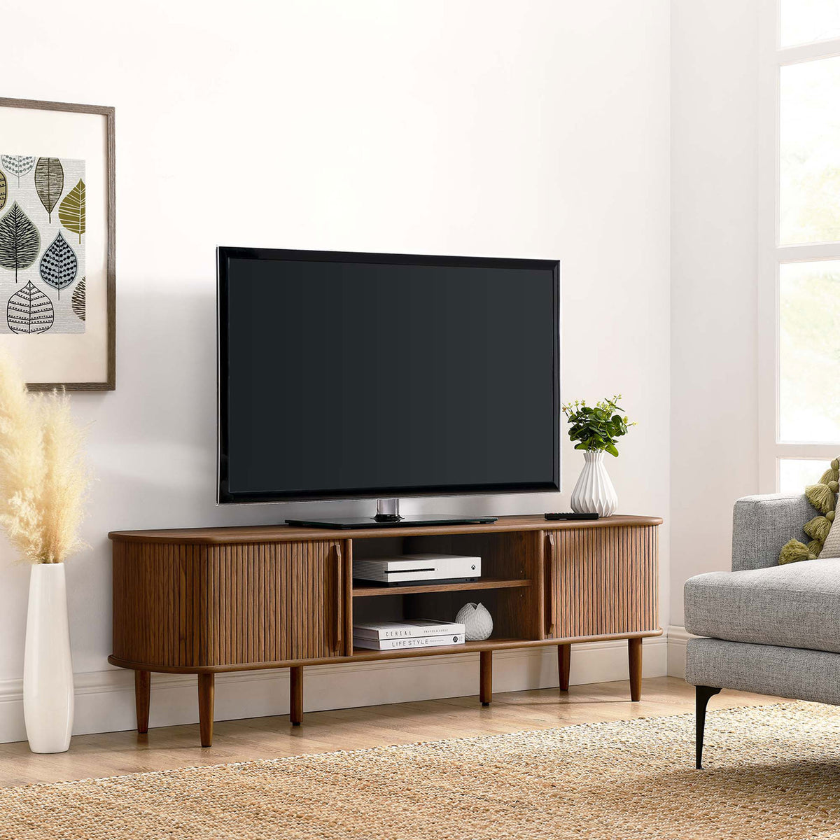 Walnut TV stand anchors a bright living room with TV, artwork, and cozy seating || EEI-6795-WAL || front_room